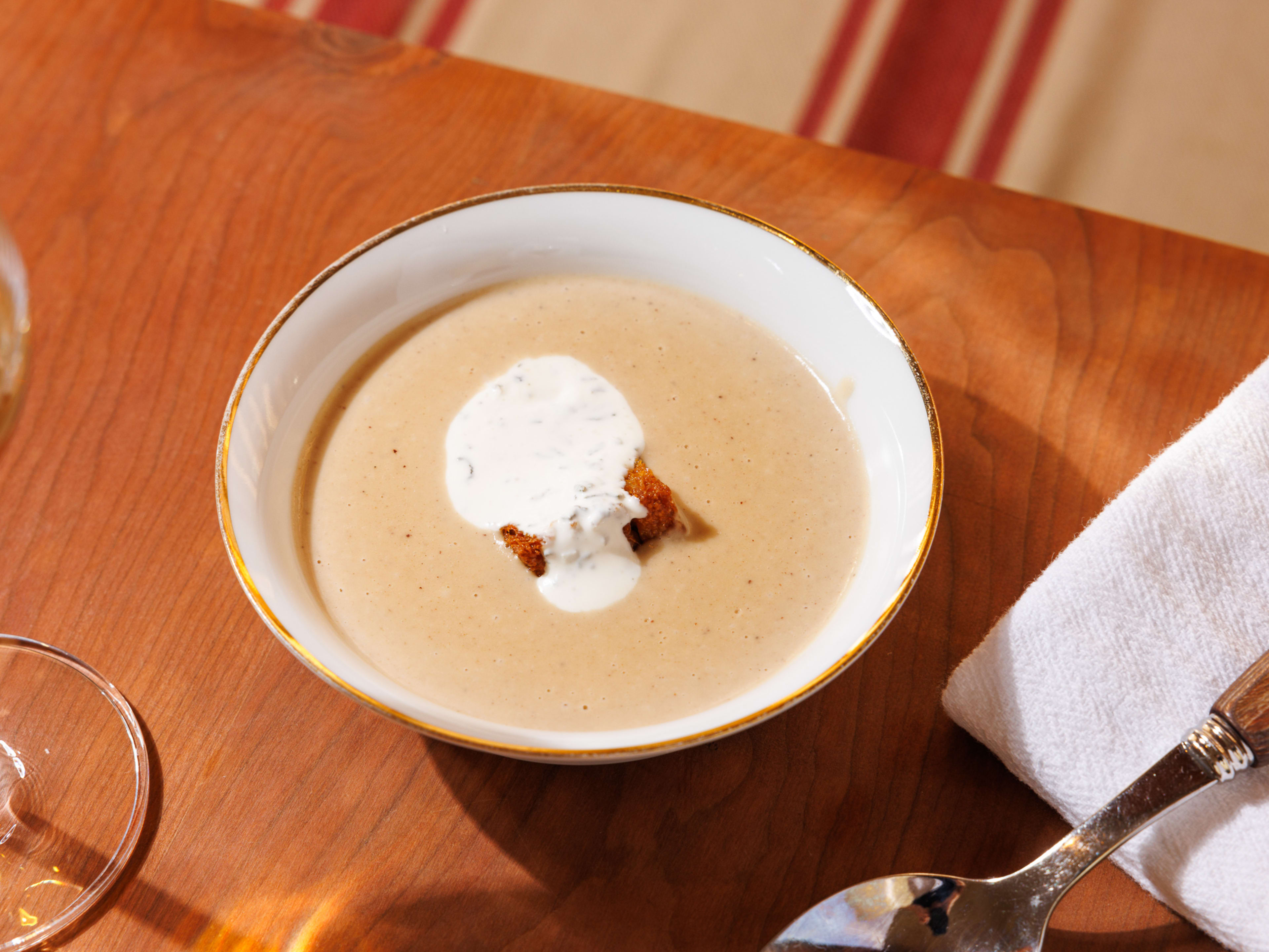 a bowl of chestnut soup with a dollop of creme fraiche in the center