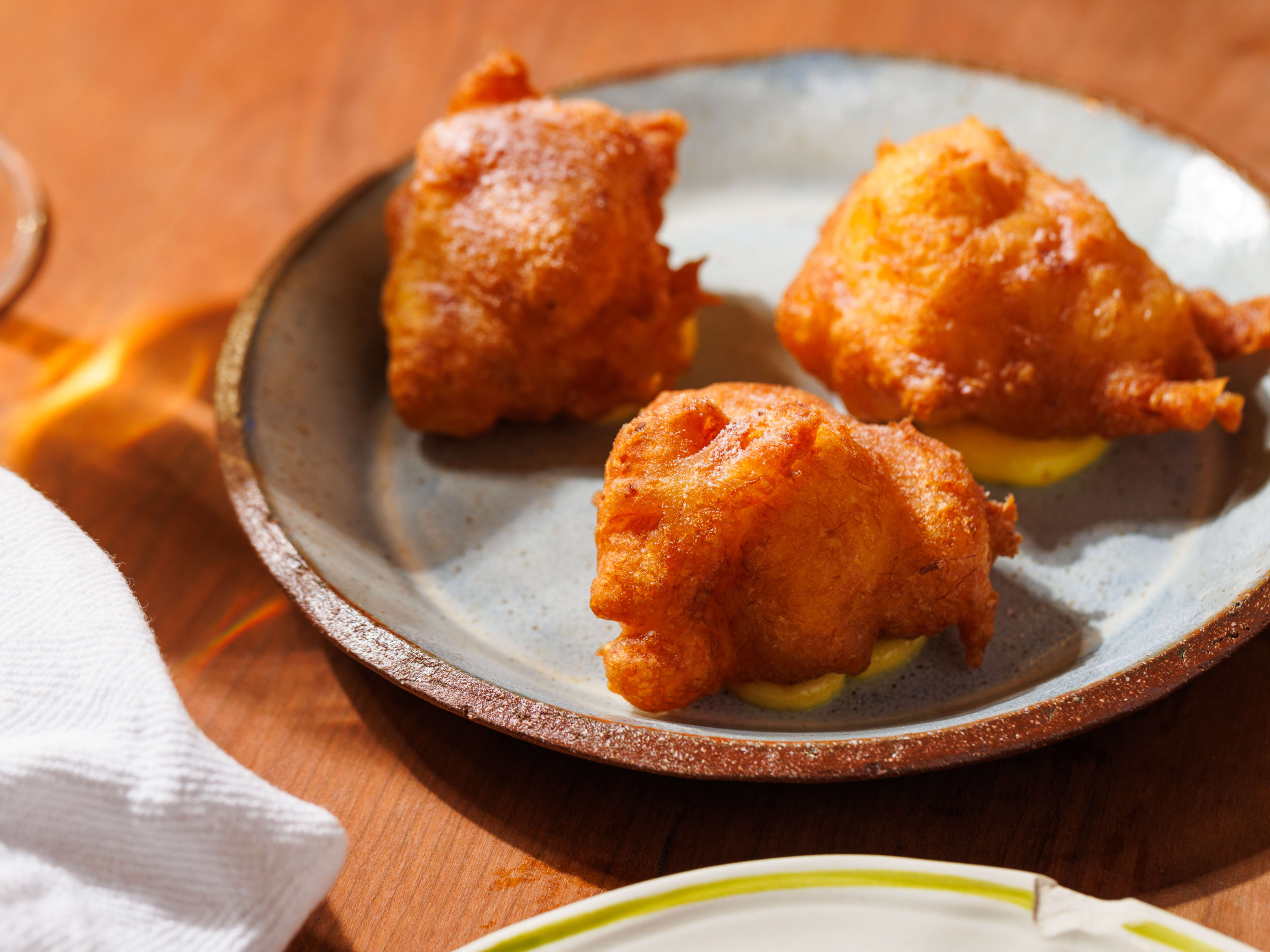 three salted cod beignets on a plate