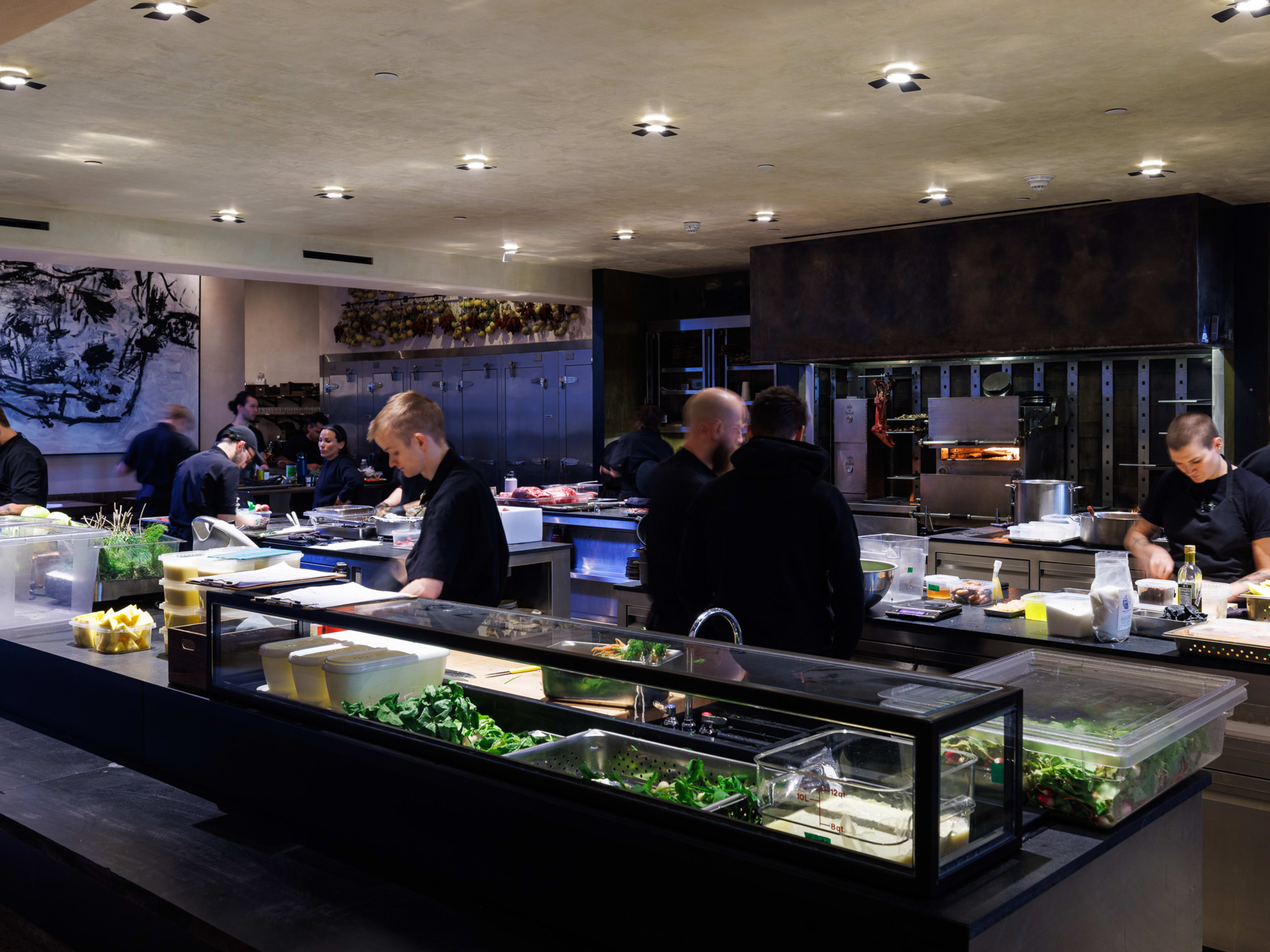 A large open kitchen with cooks moving about.