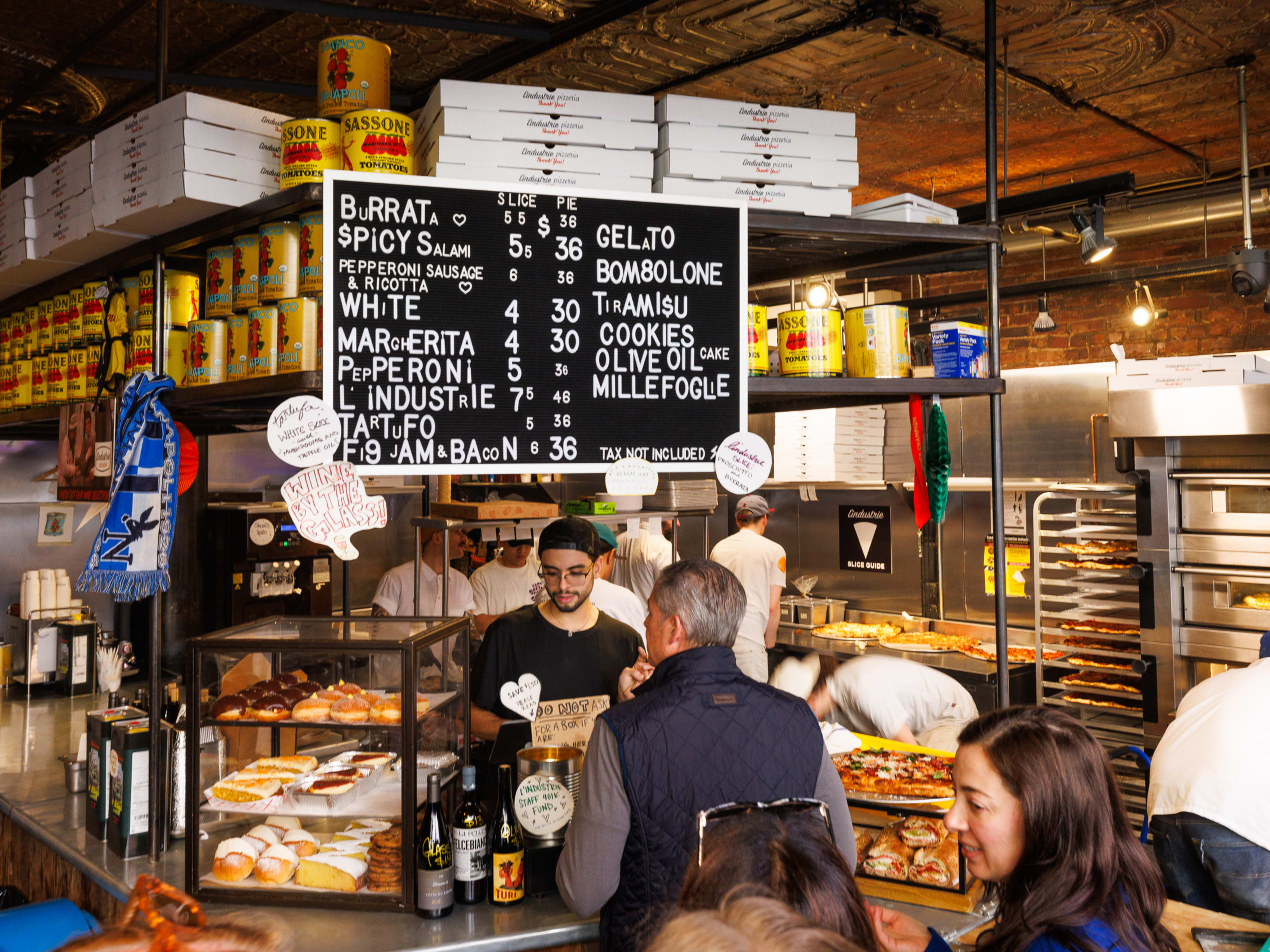 the interior and menu board at L'Industrie in the West Village