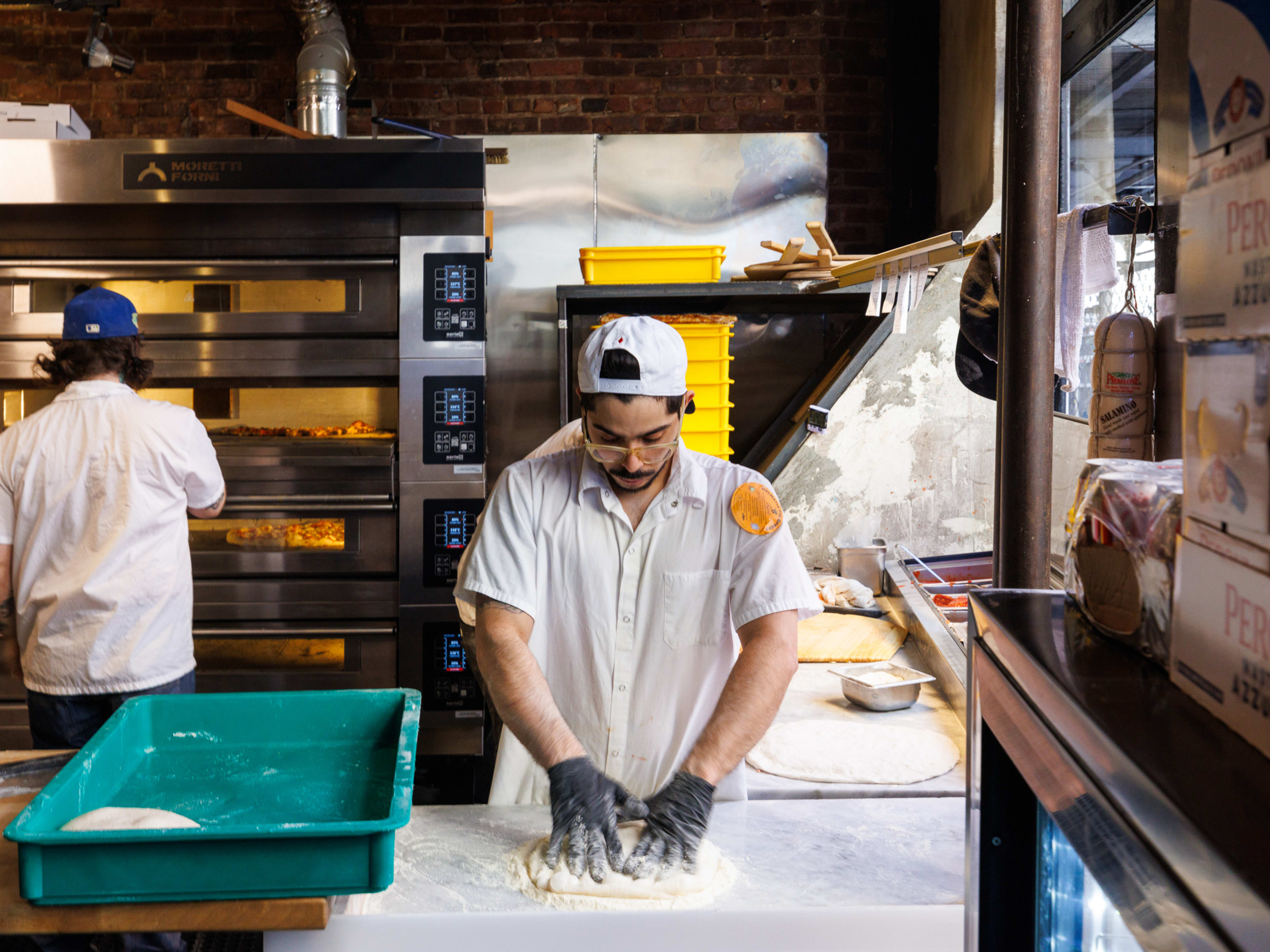 a man making pizzas at L'Industrie in the West Village