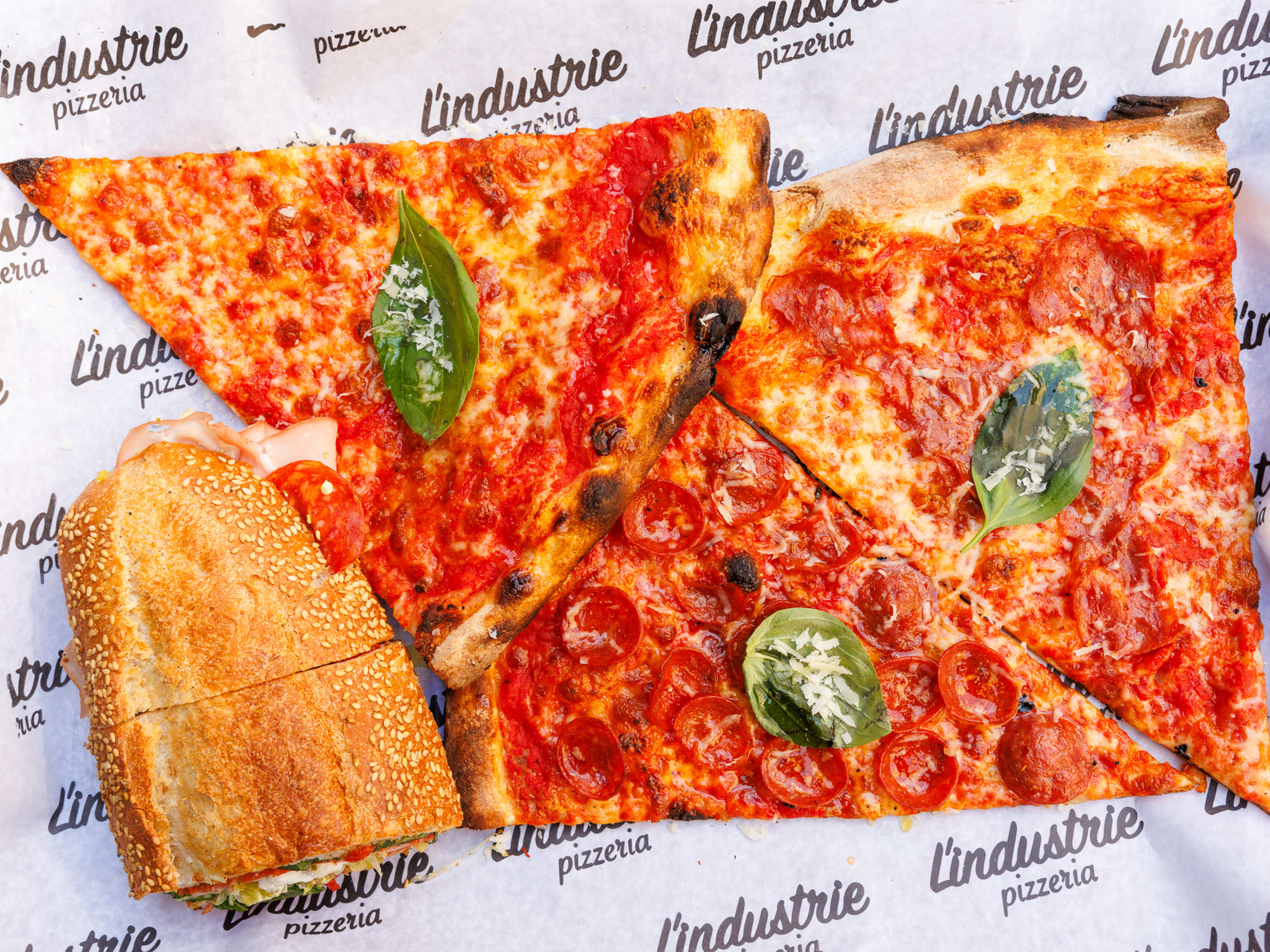 three slices of pizza and a sandwich from L'Industrie West Village