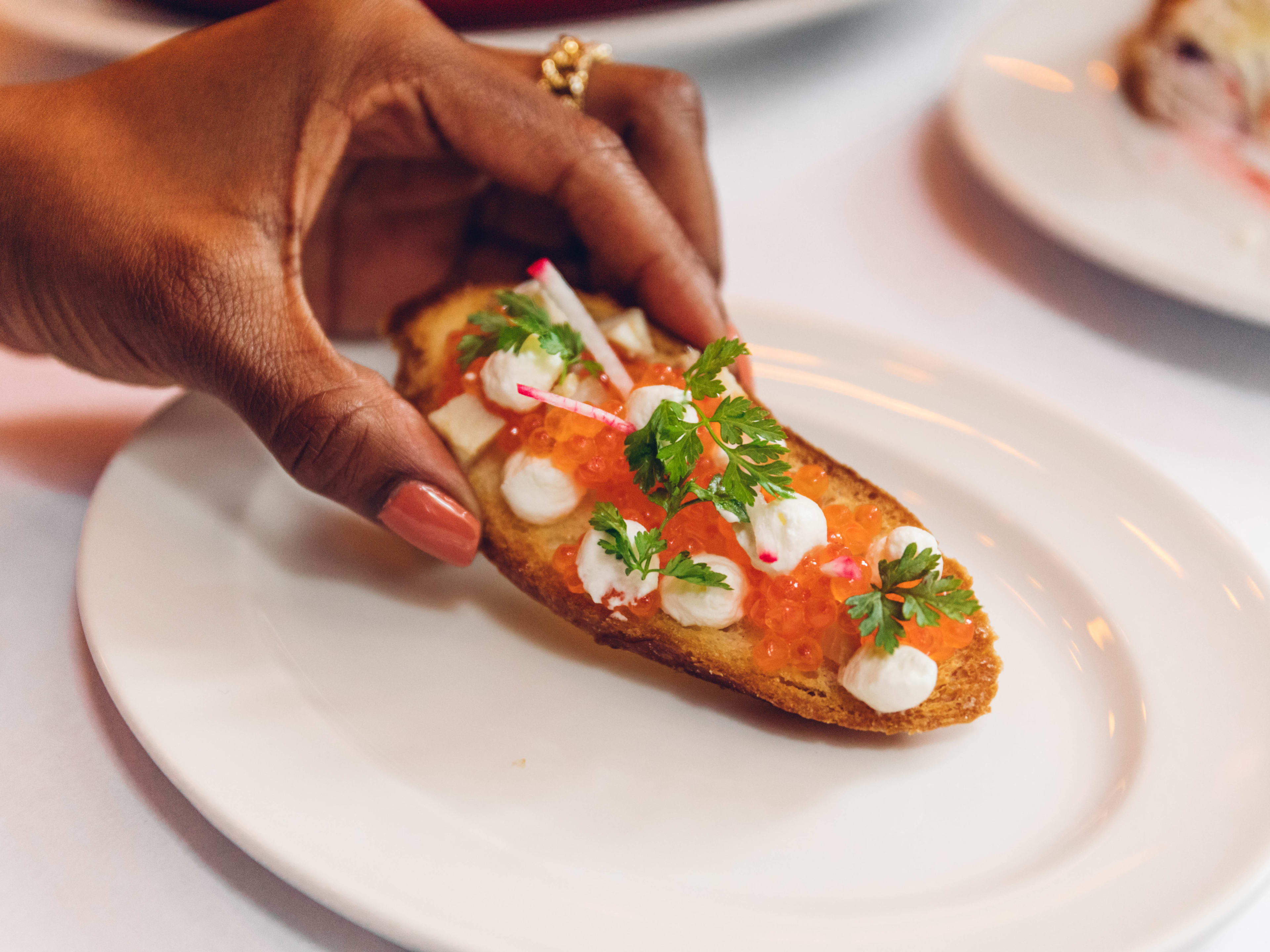 A piece of toast topped with trout roe.