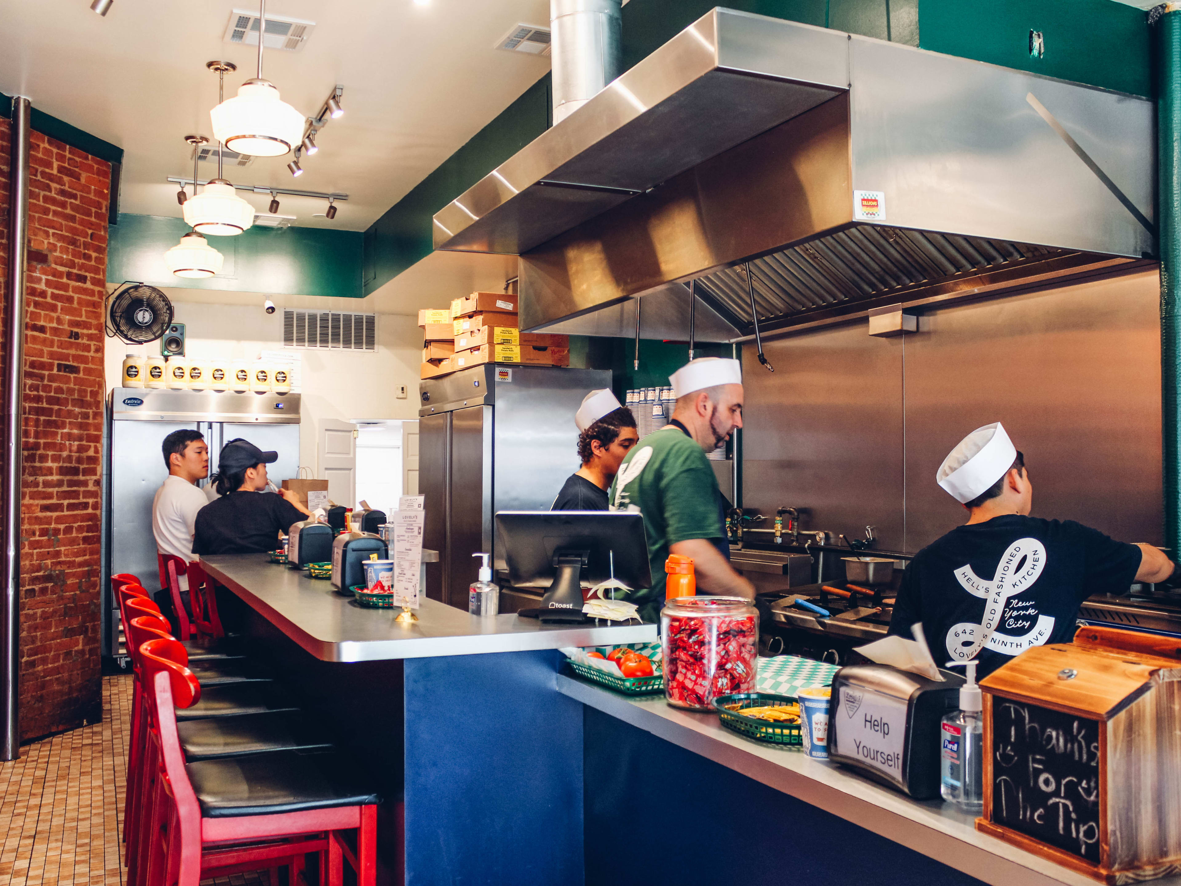 Chefs cook in the open kitchen at Lovely’s Old Fashioned.