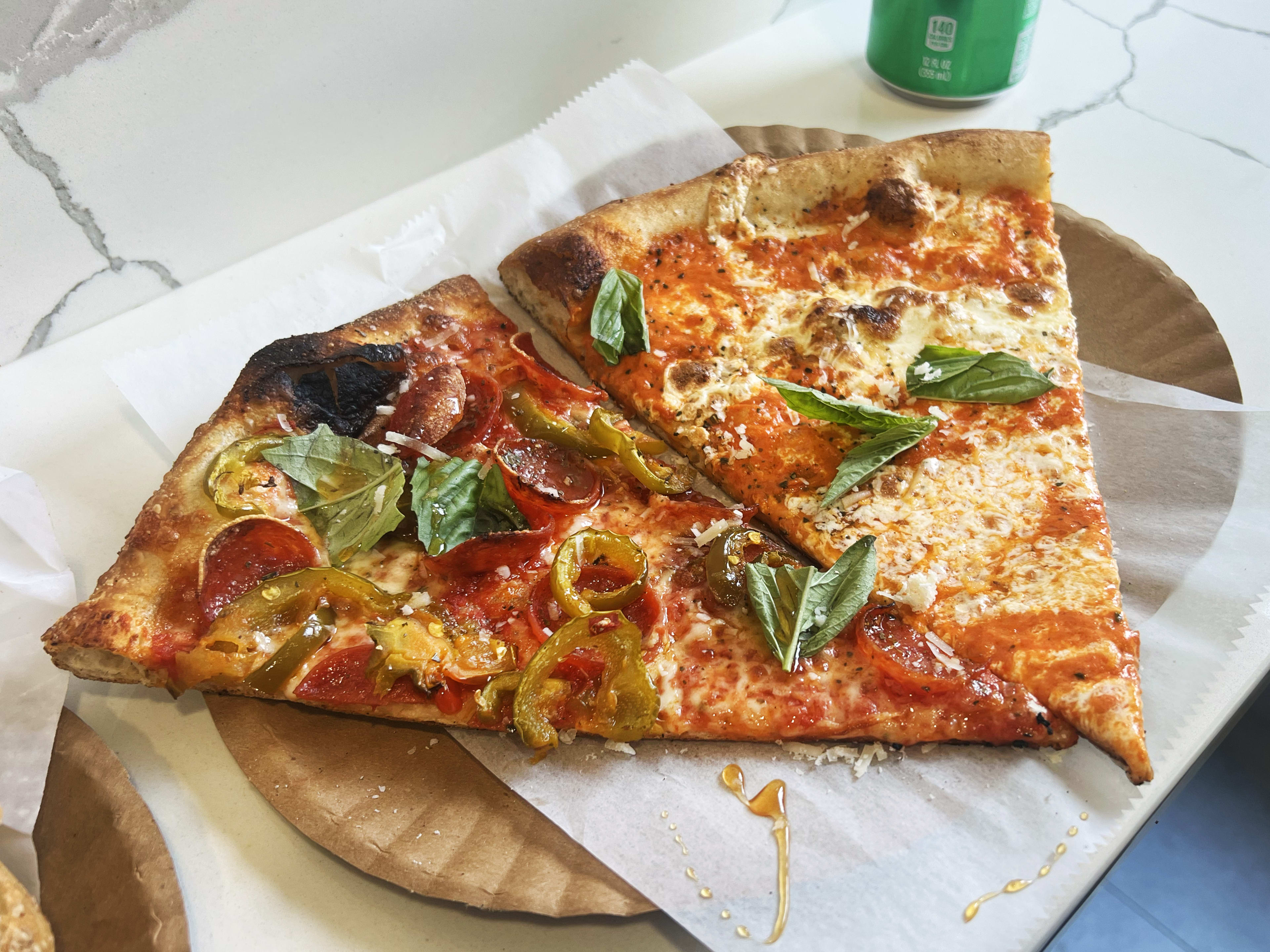 Two slices of pizza at Lucia Pizza of Soho.