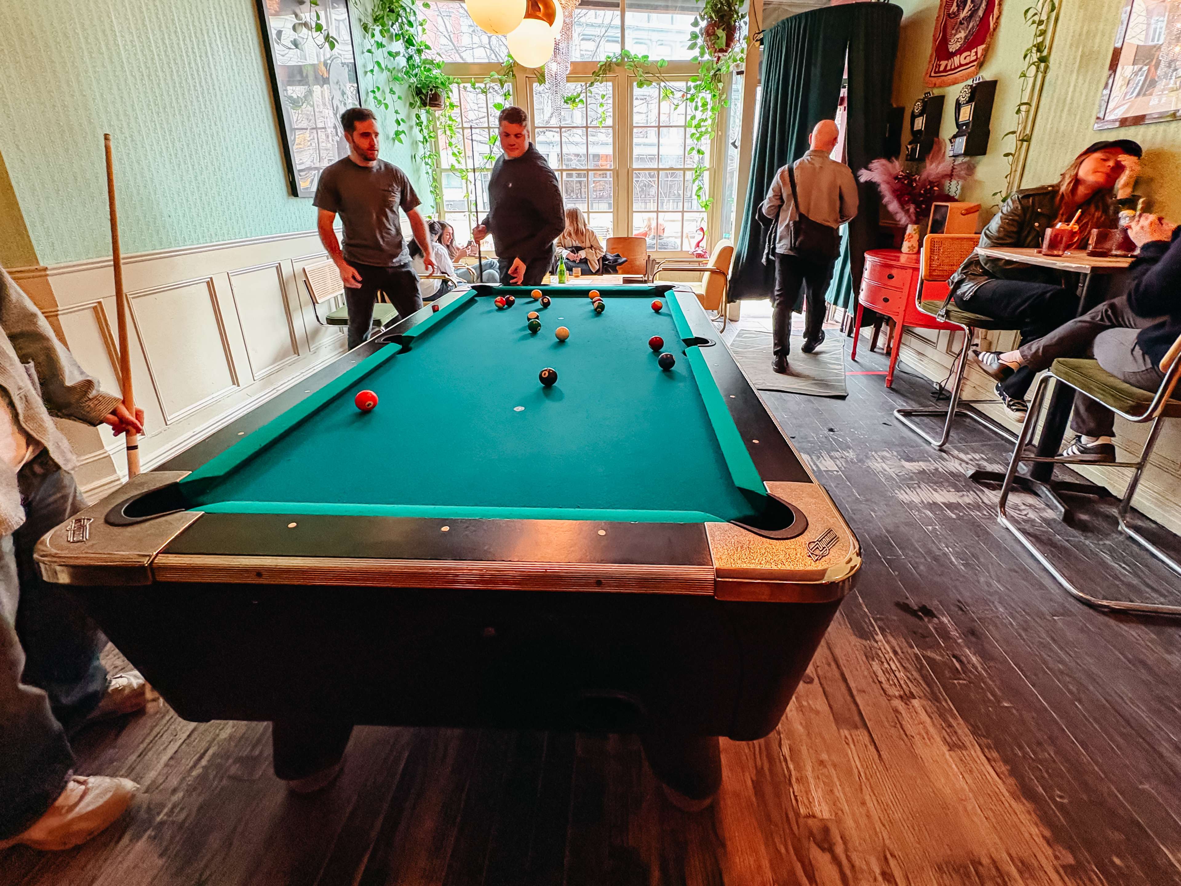 a pool table in a bright bar