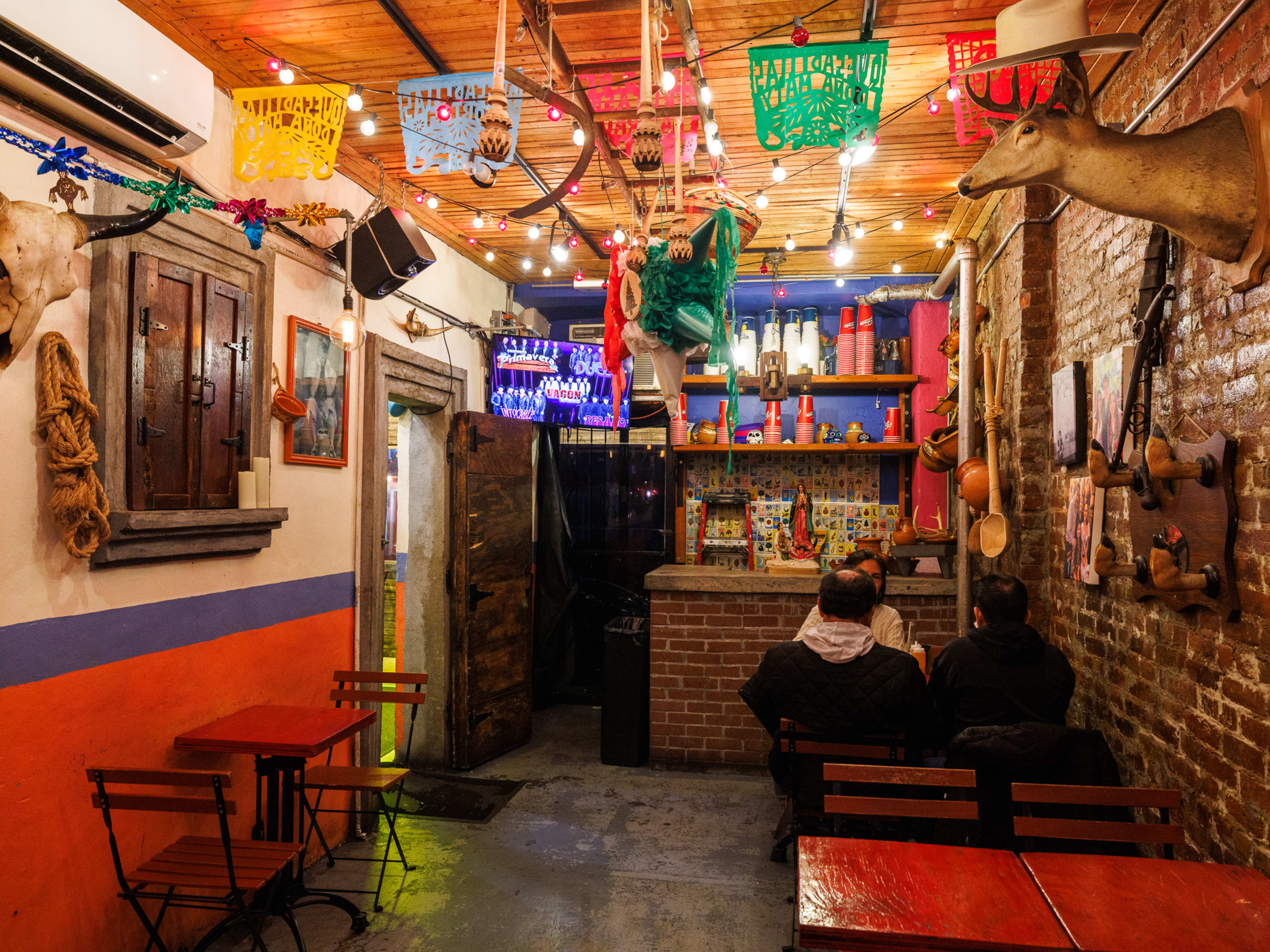 The interior of Quesadillas Doña Maty with people sitting at a table.