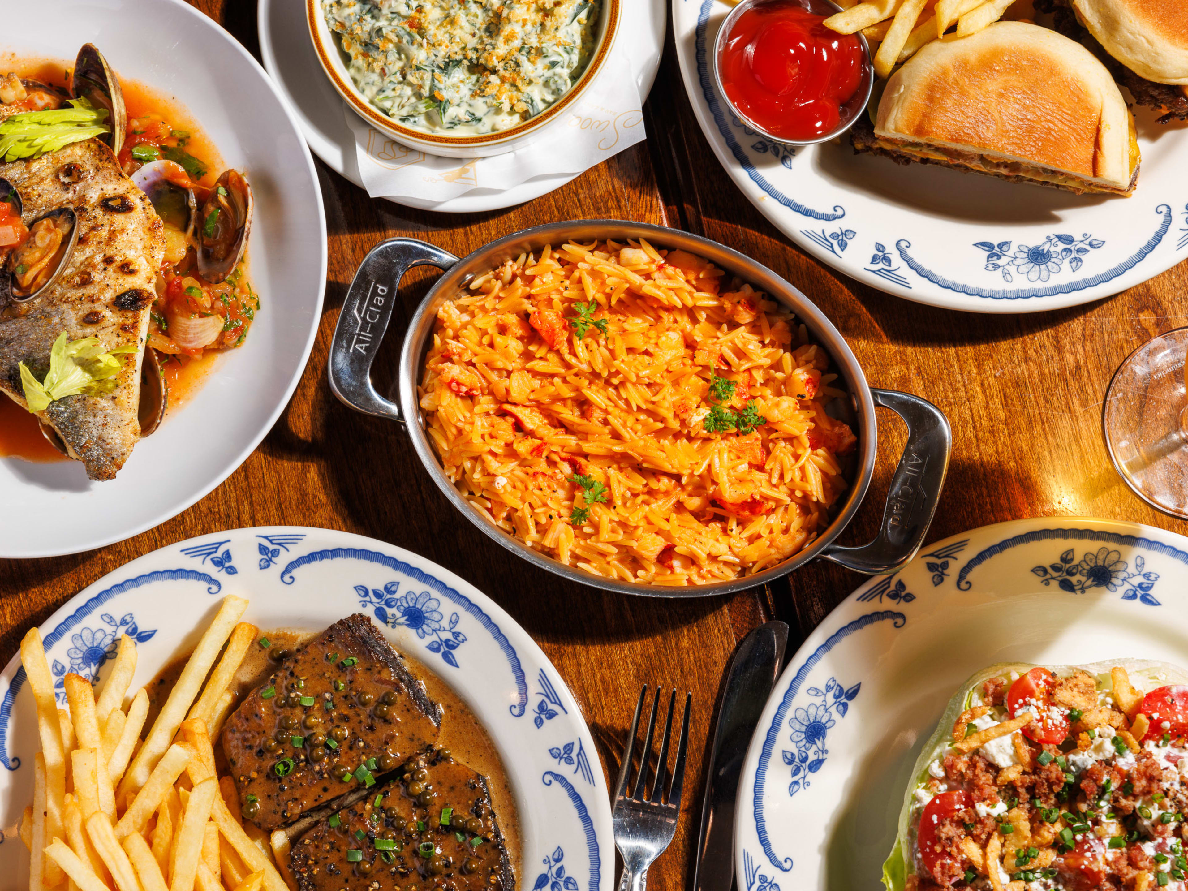 Fish, orzo, burger, creamed spinach, iceberg salad, short rib, and fries at Swoony's.