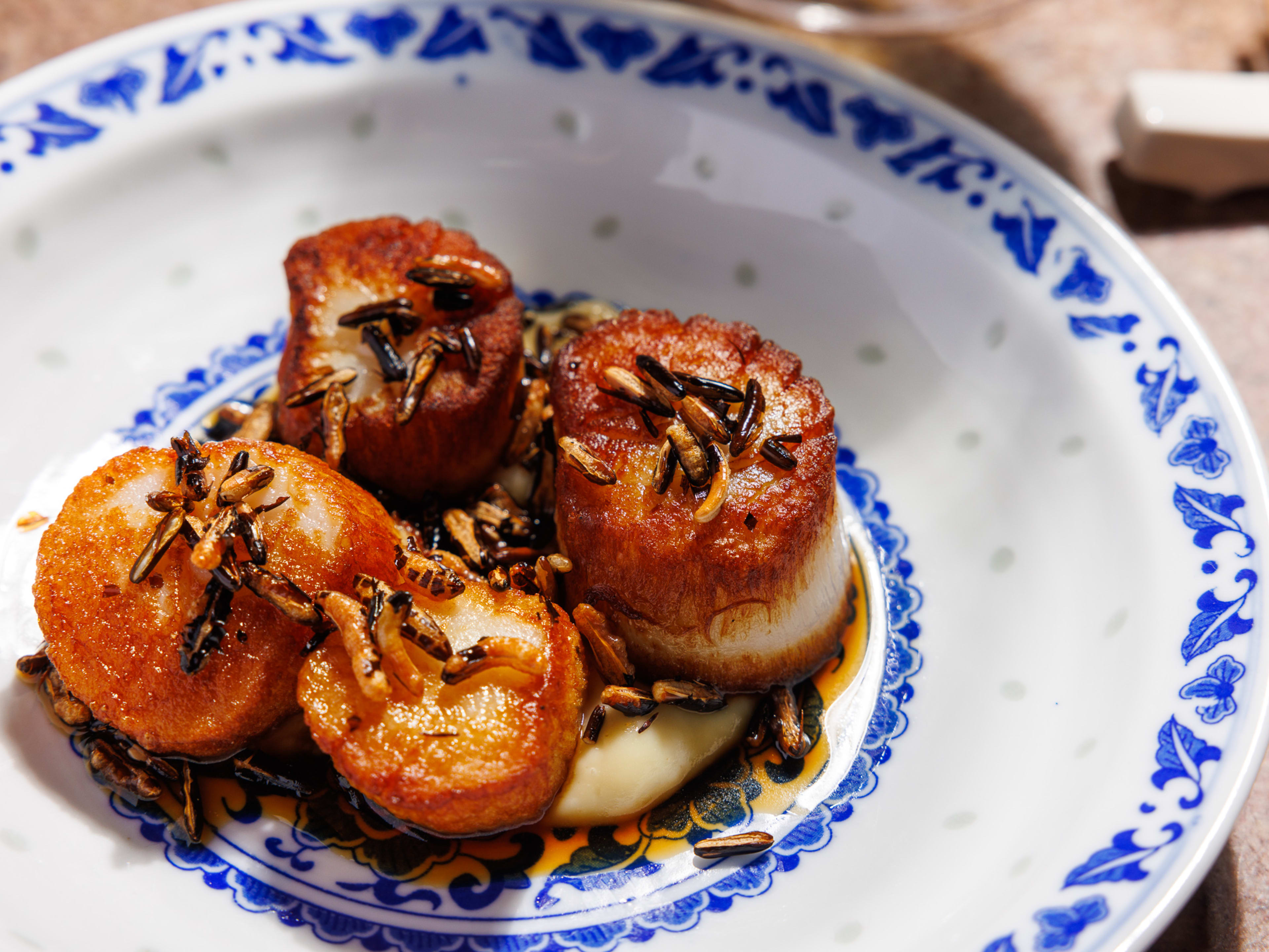 four seared scallops with puffed rice