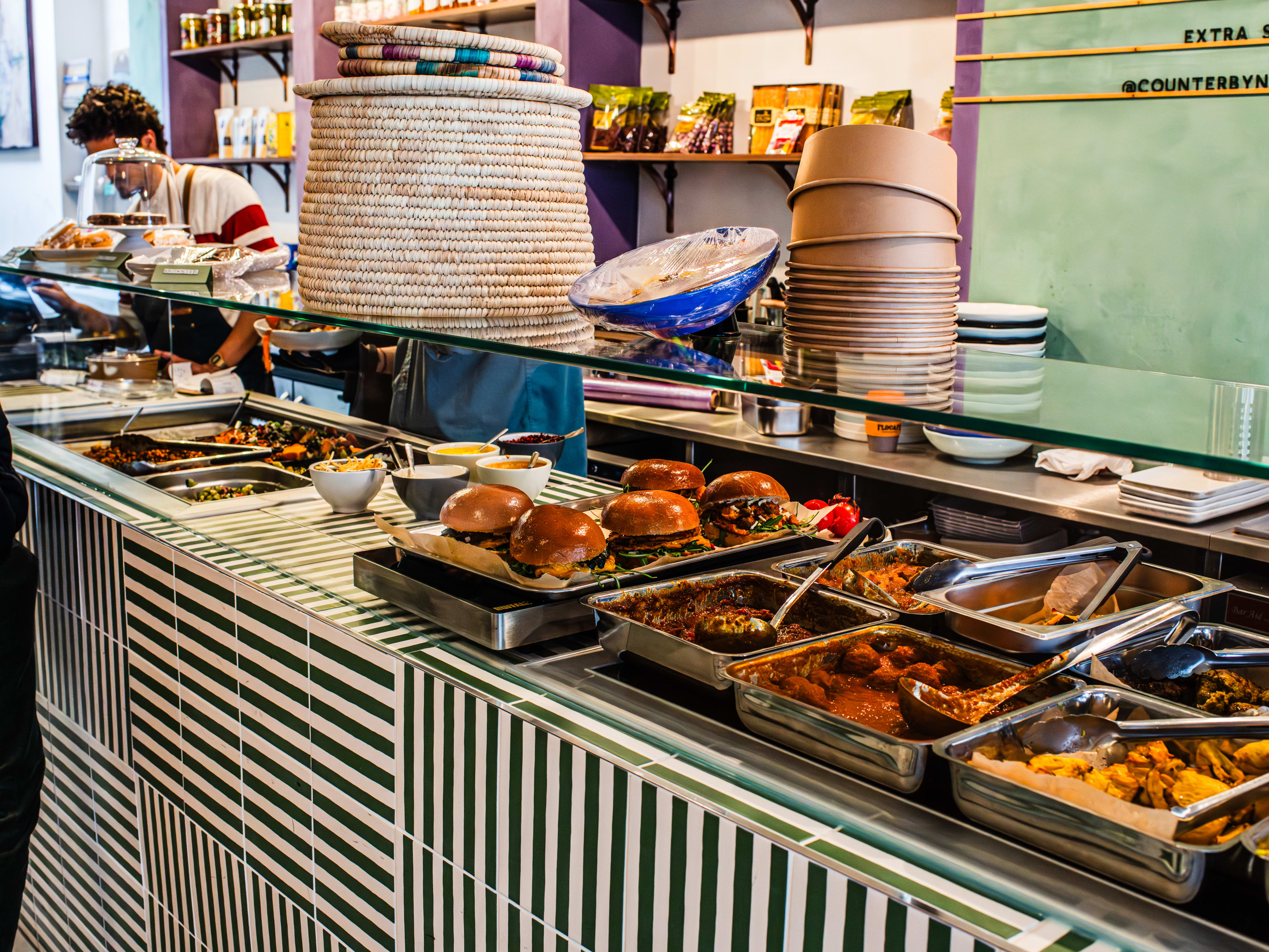 The ordering counter at Counter by Naroon with various prepared options to add to your bowl.