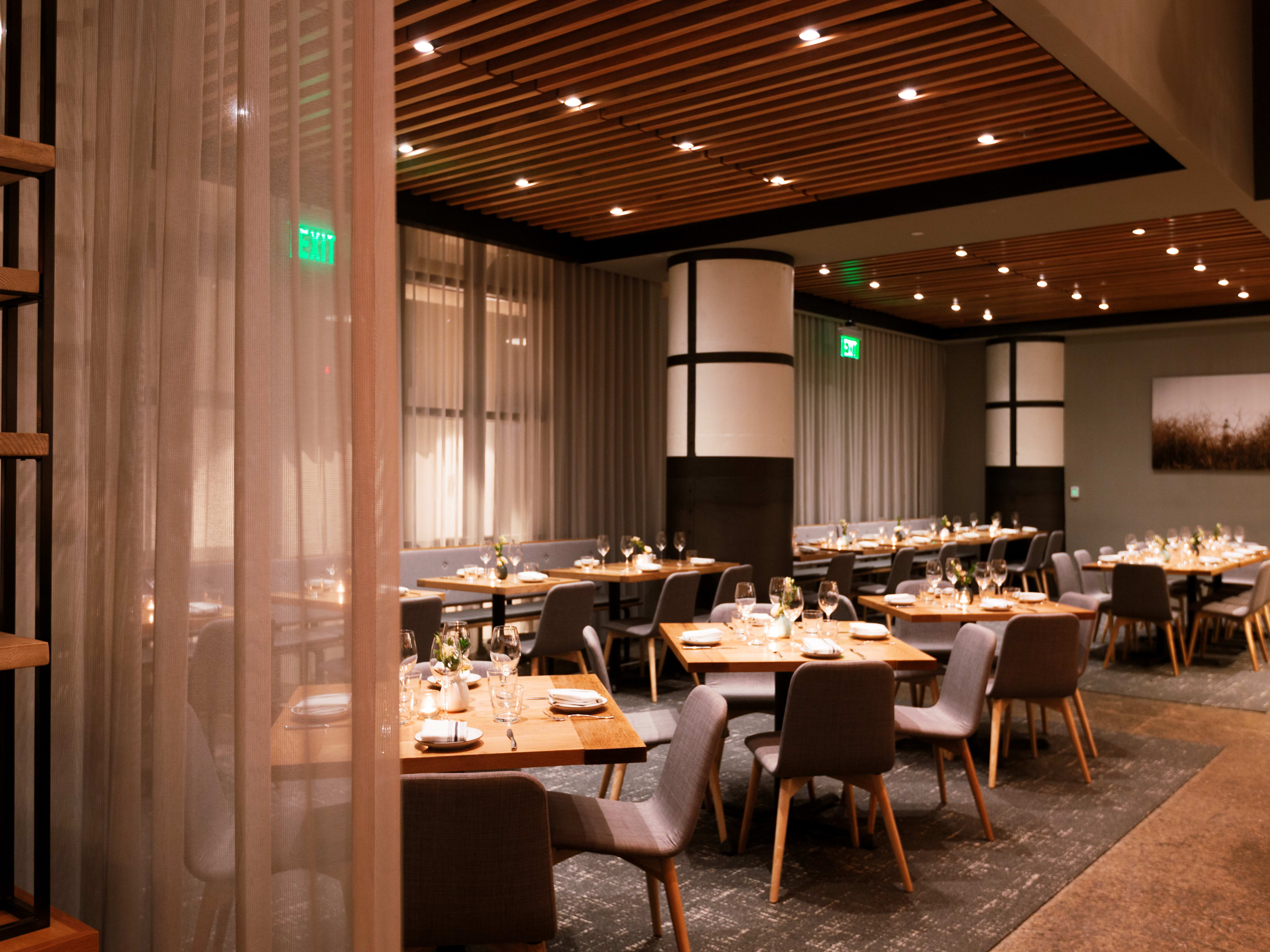 Interior dining space with tables set for service at Chickadee