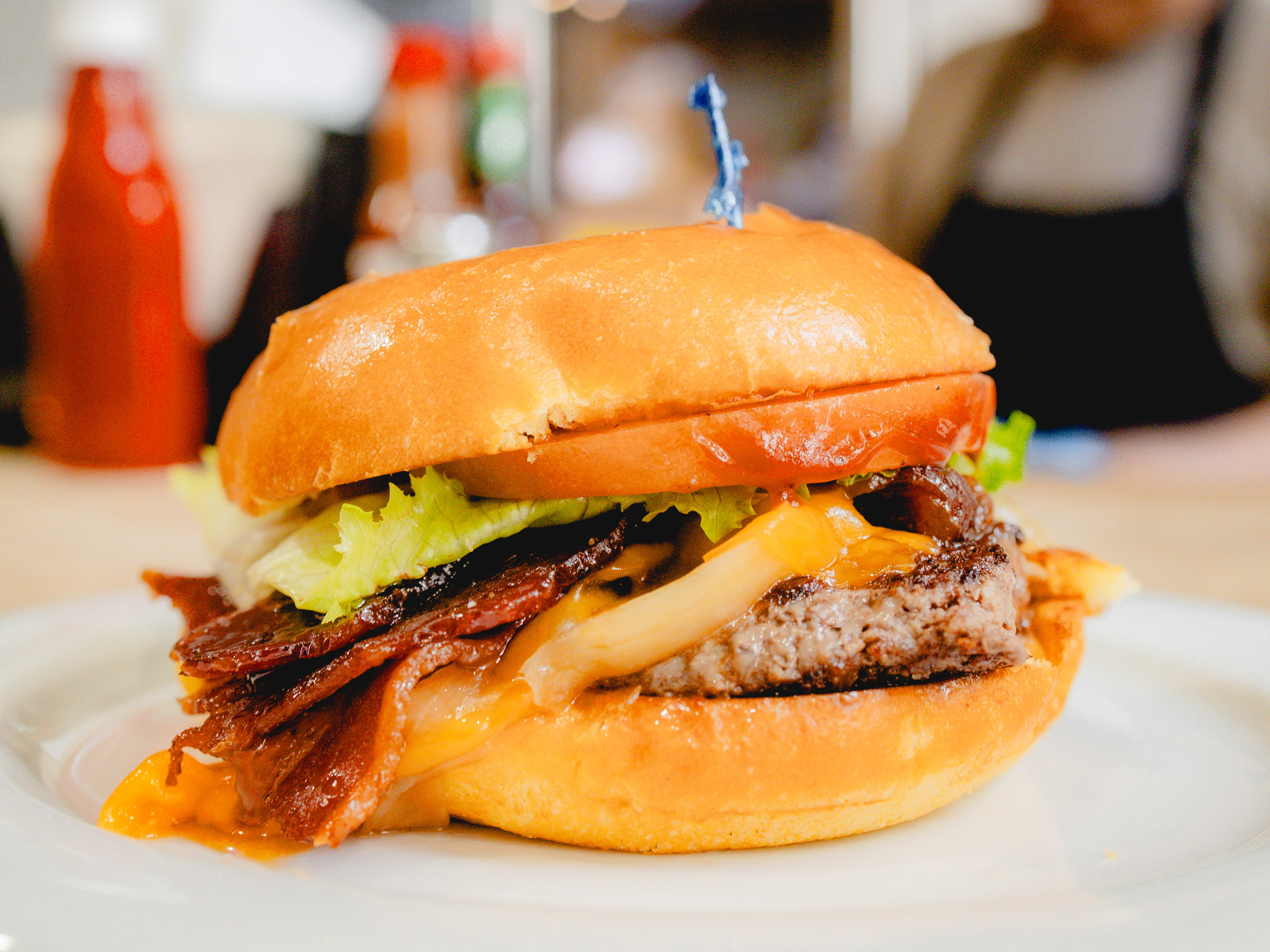 burger with bacon cheese lettuce tomato patty and fluffy bun