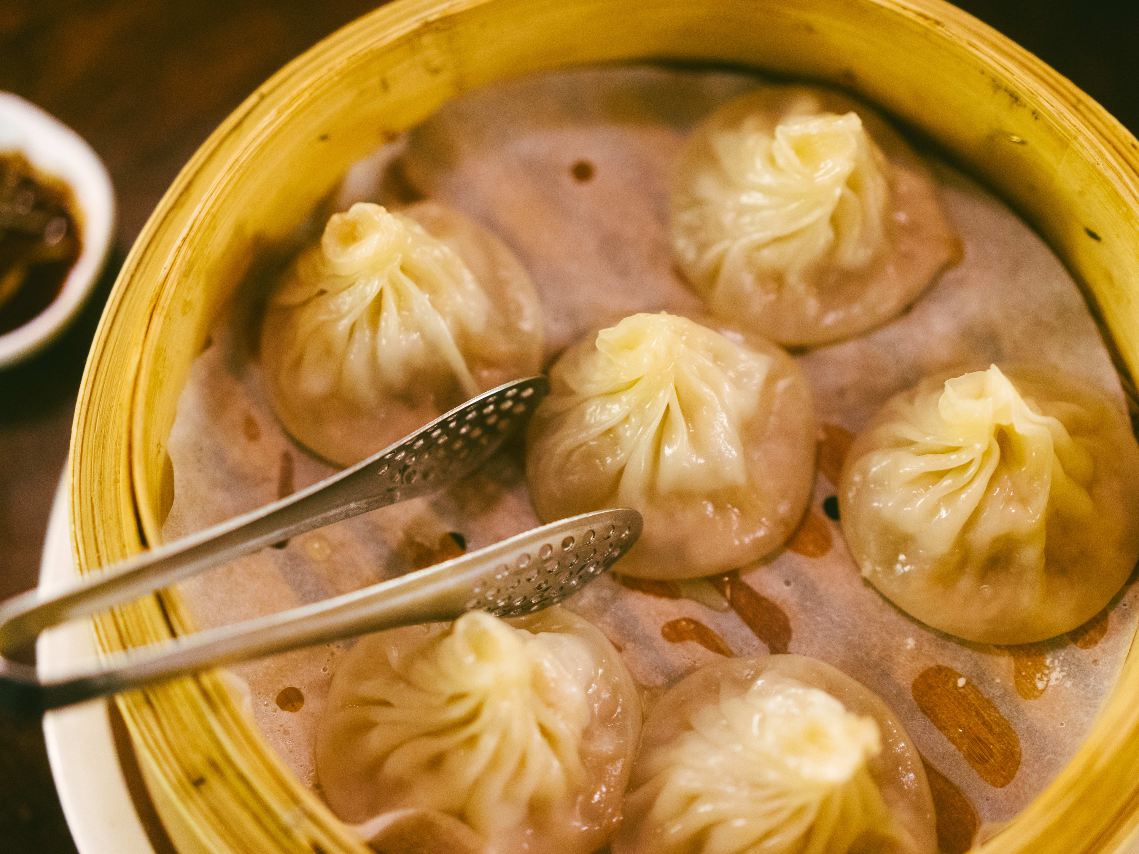 The soup dumplings in a steamer basket from Noodle Village.