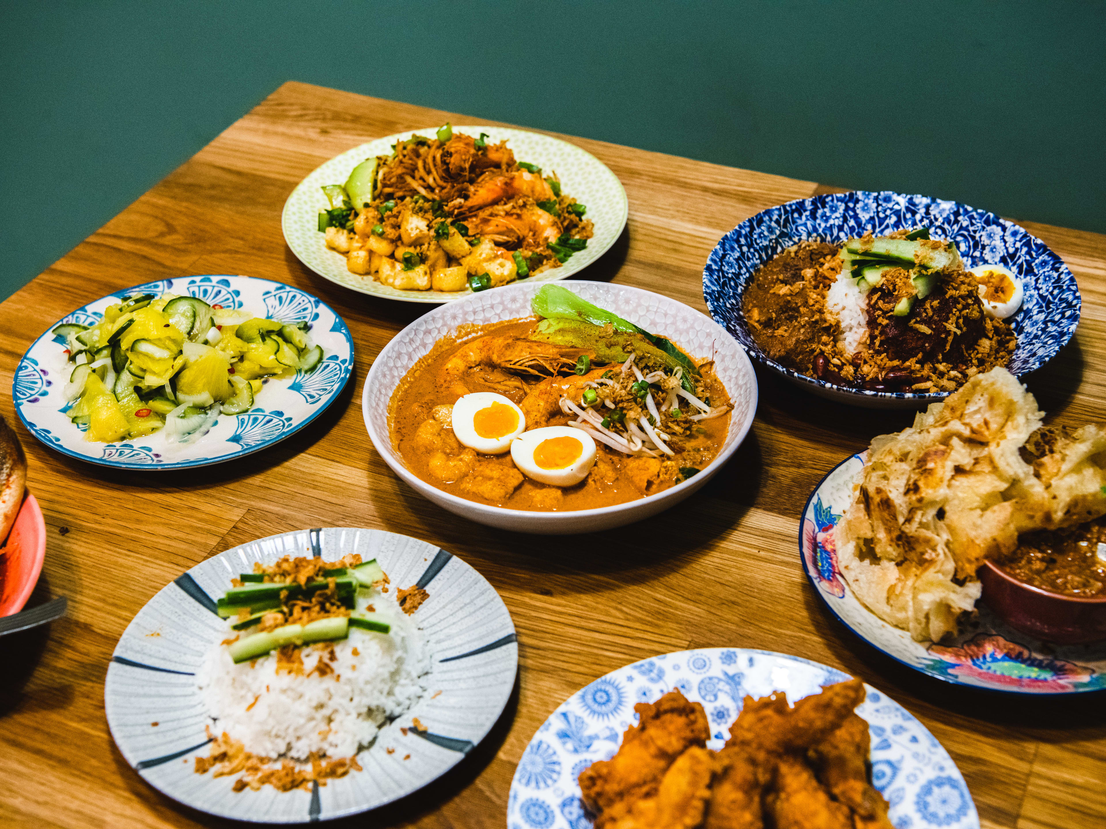 A spread of dishes on a wooden table.