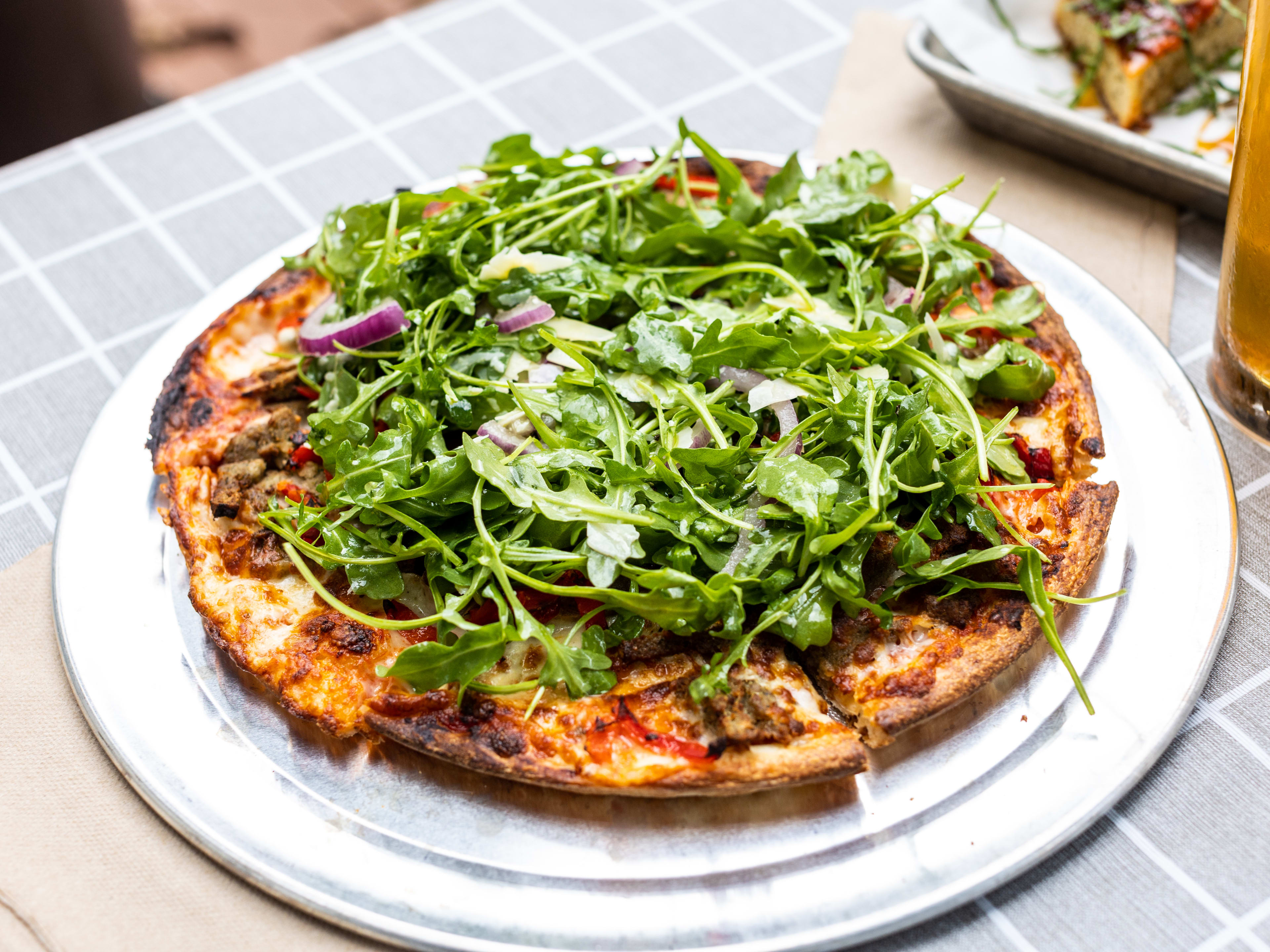 The That's Amore pizza from Oddwood Brewing served on a metal tray.