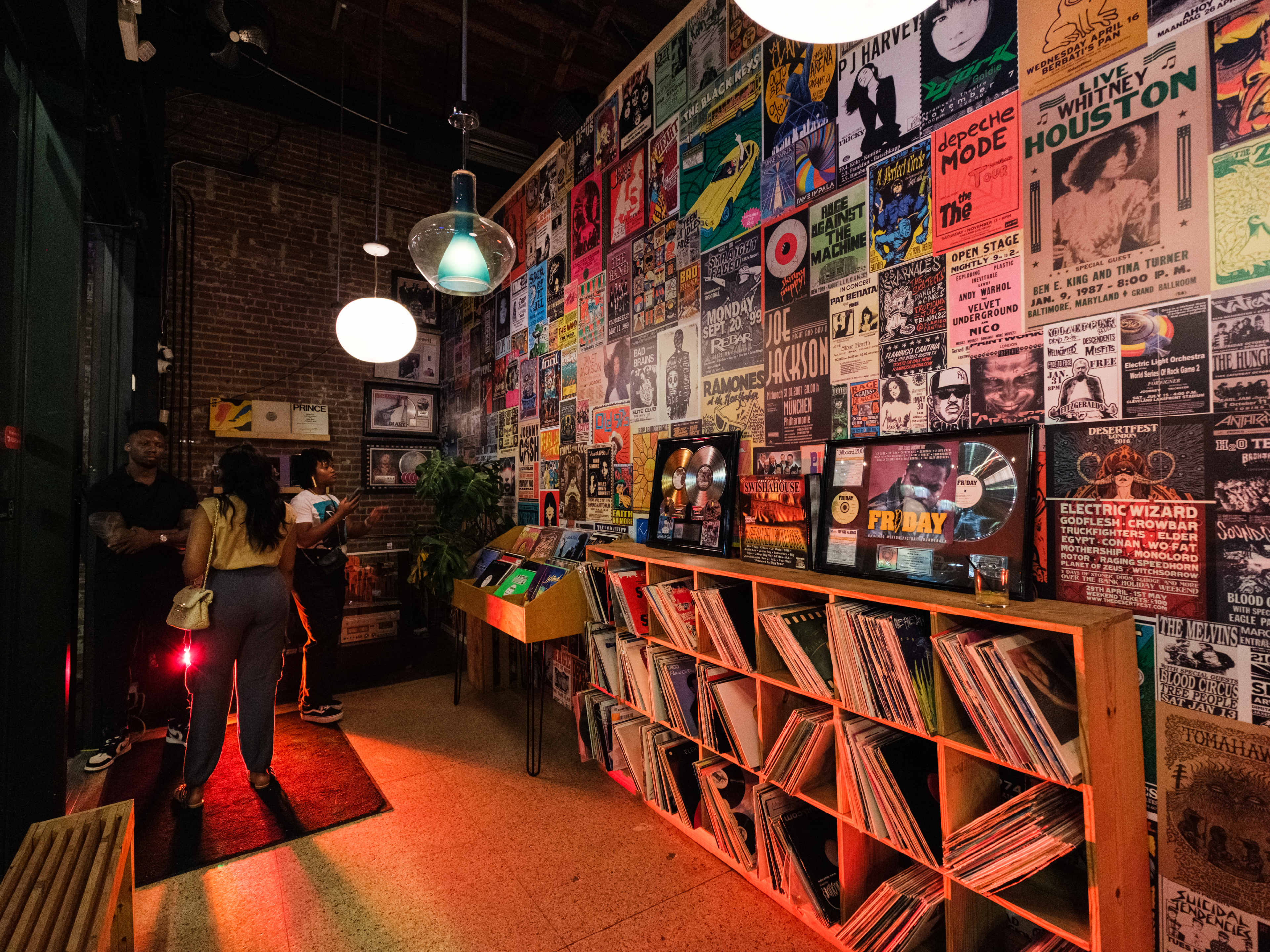 The front entrance of Off The Record. Records line shelves and concert posters cover the wall.