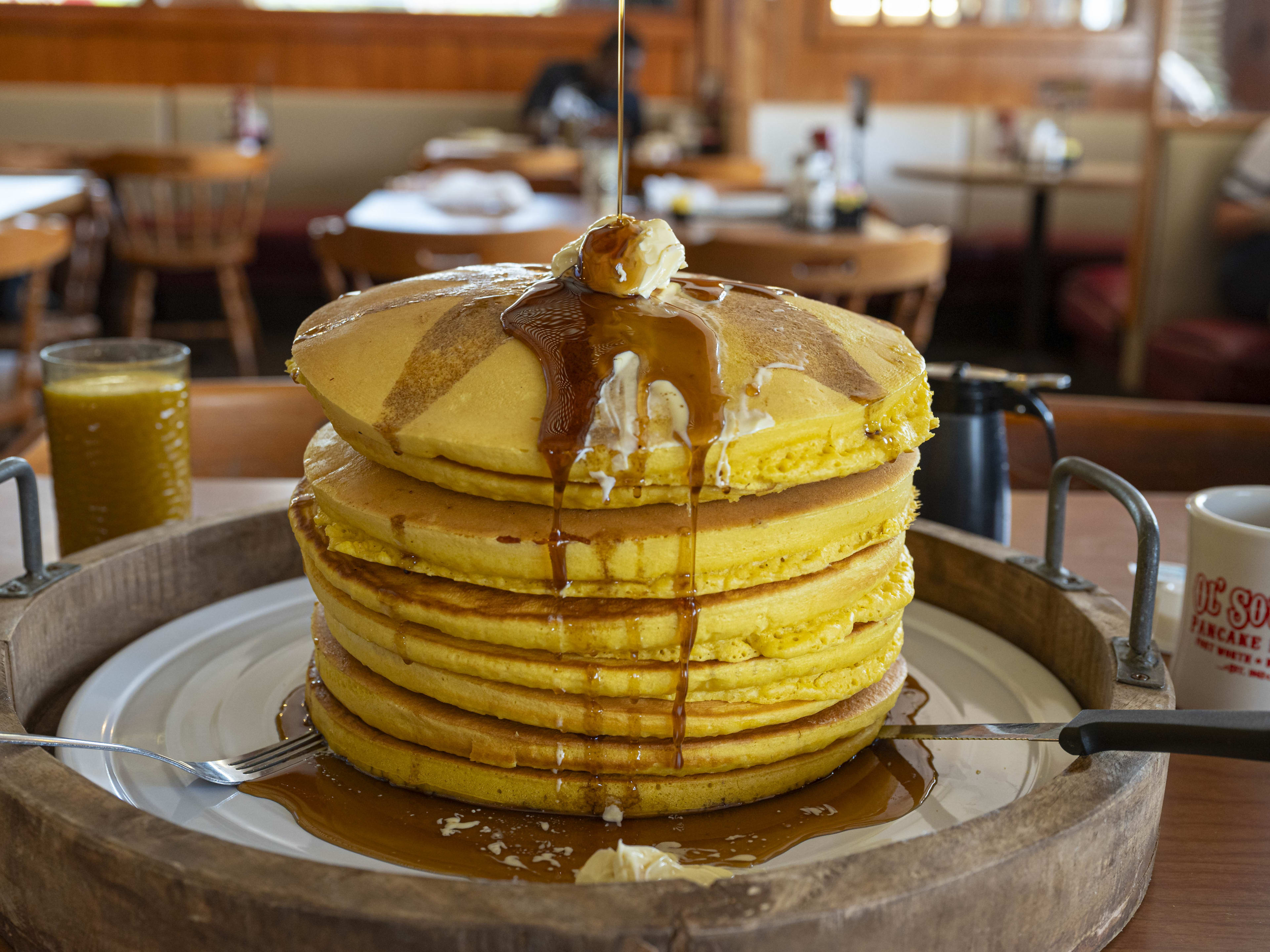 A huge stack of pancakes on a table at Ol South Pancake House