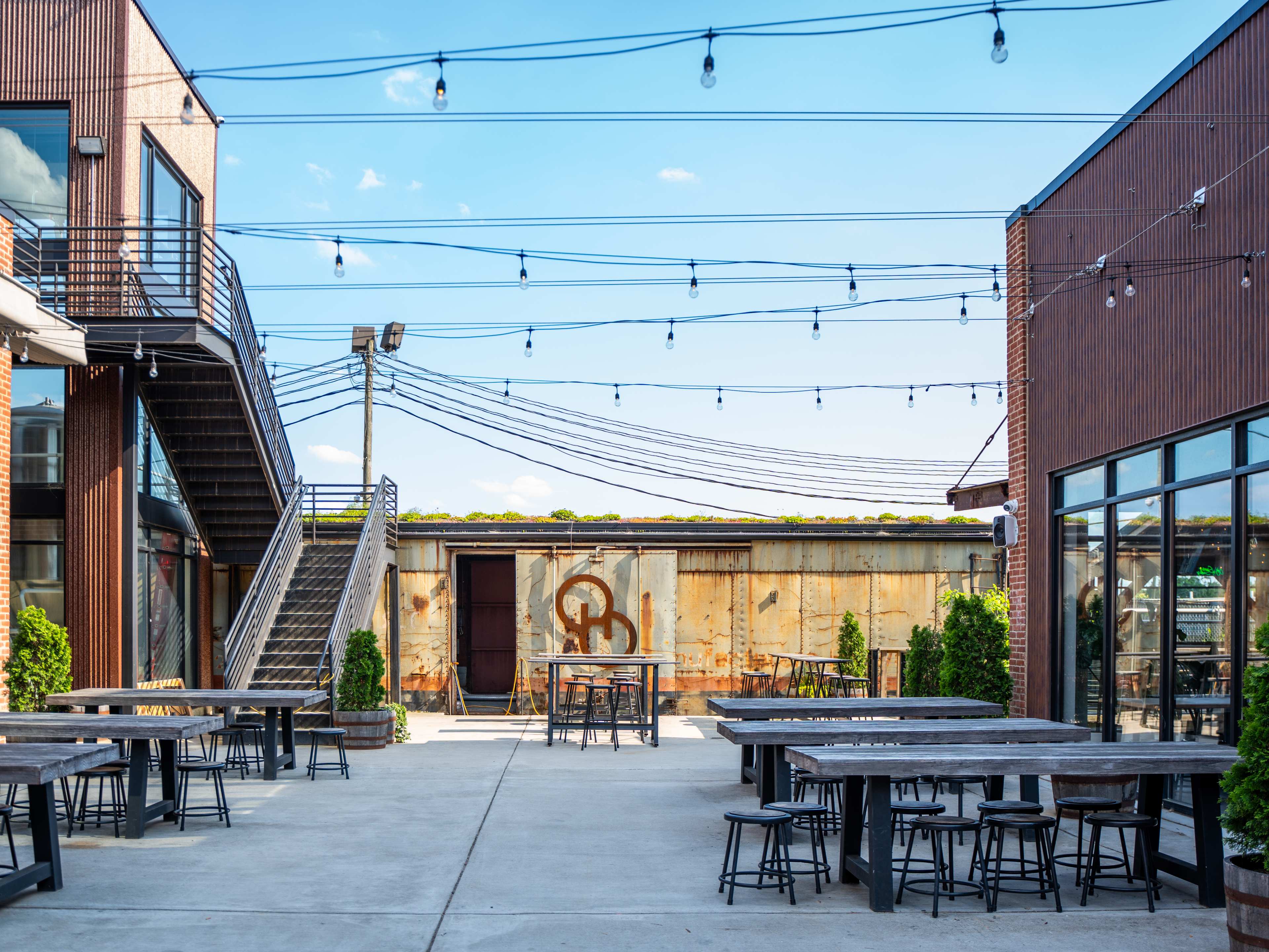 courtyard of brewery with string lights and lots of seating