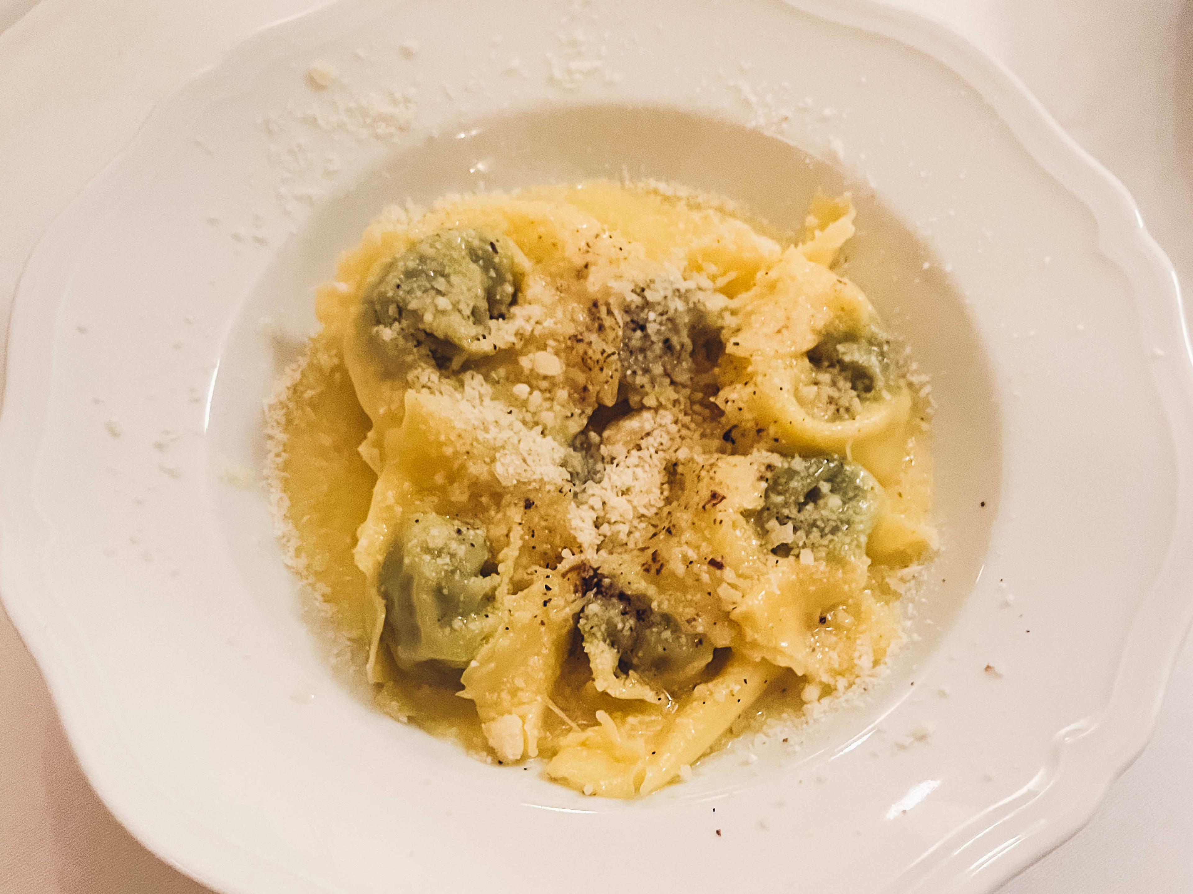 Pasta in a white bowl on a table at Localino, a restaurant in Paris