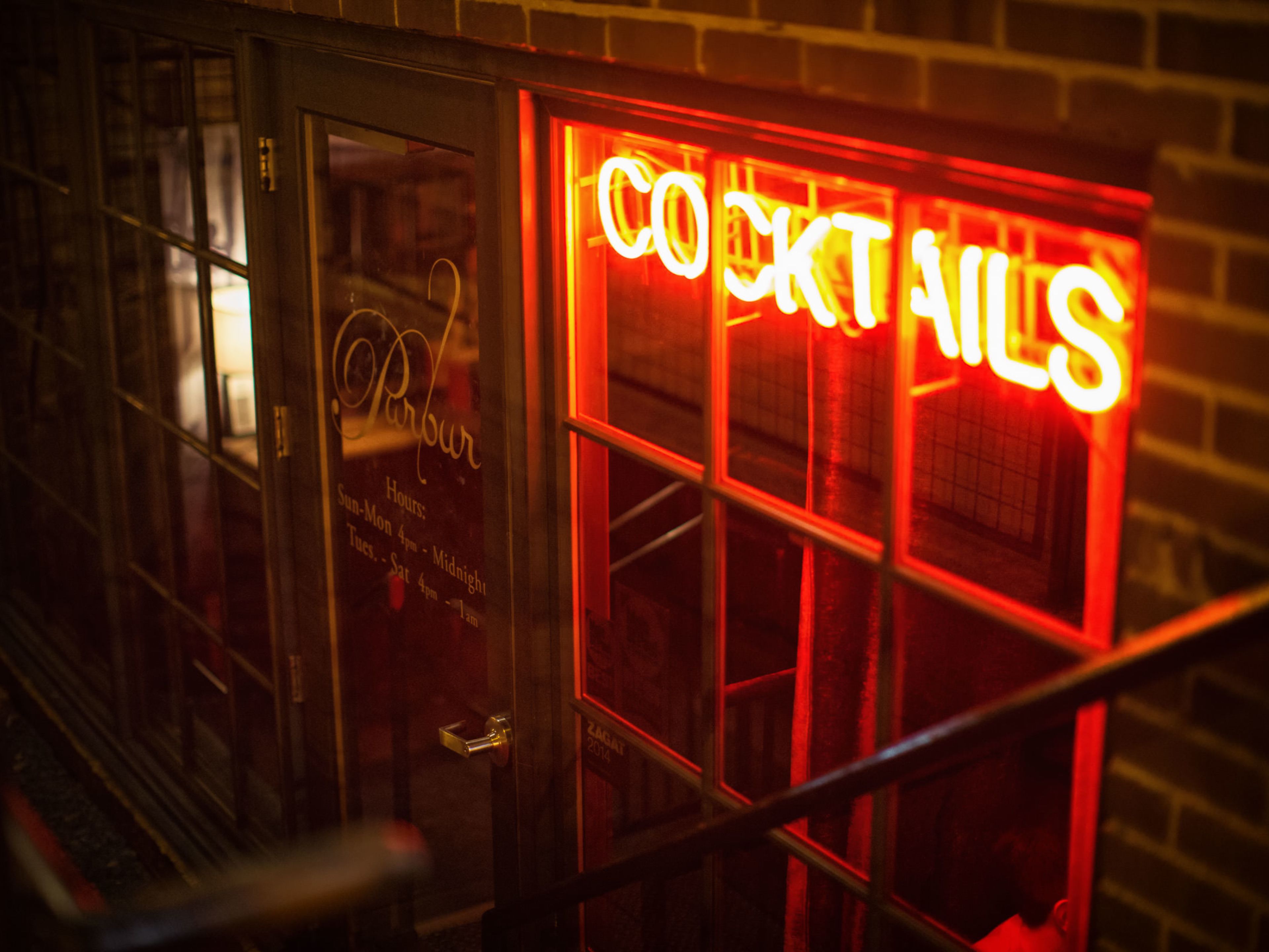Exterior of Parlour with red neon cocktail sign