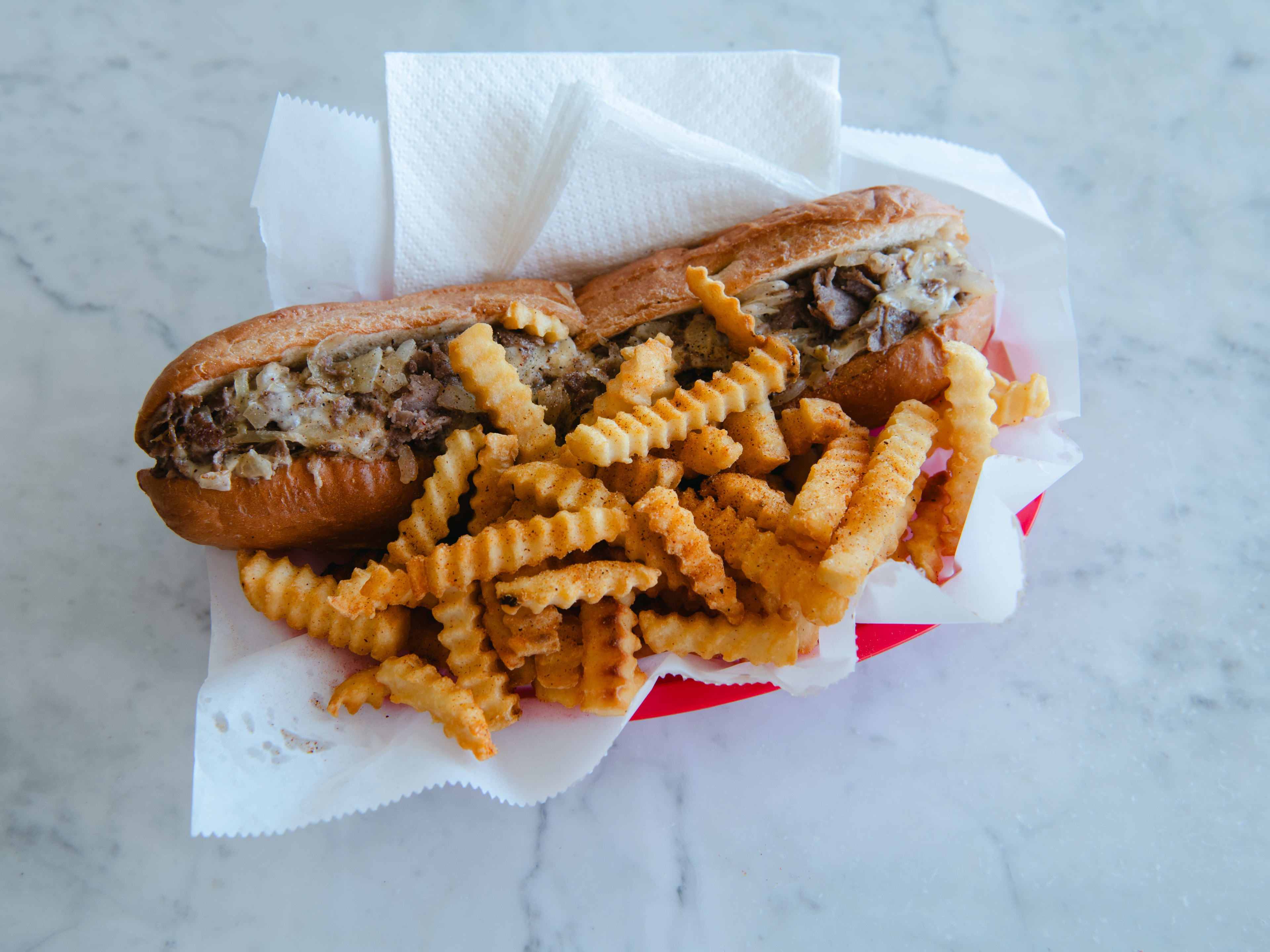 A cheesesteak and crinkle fries.