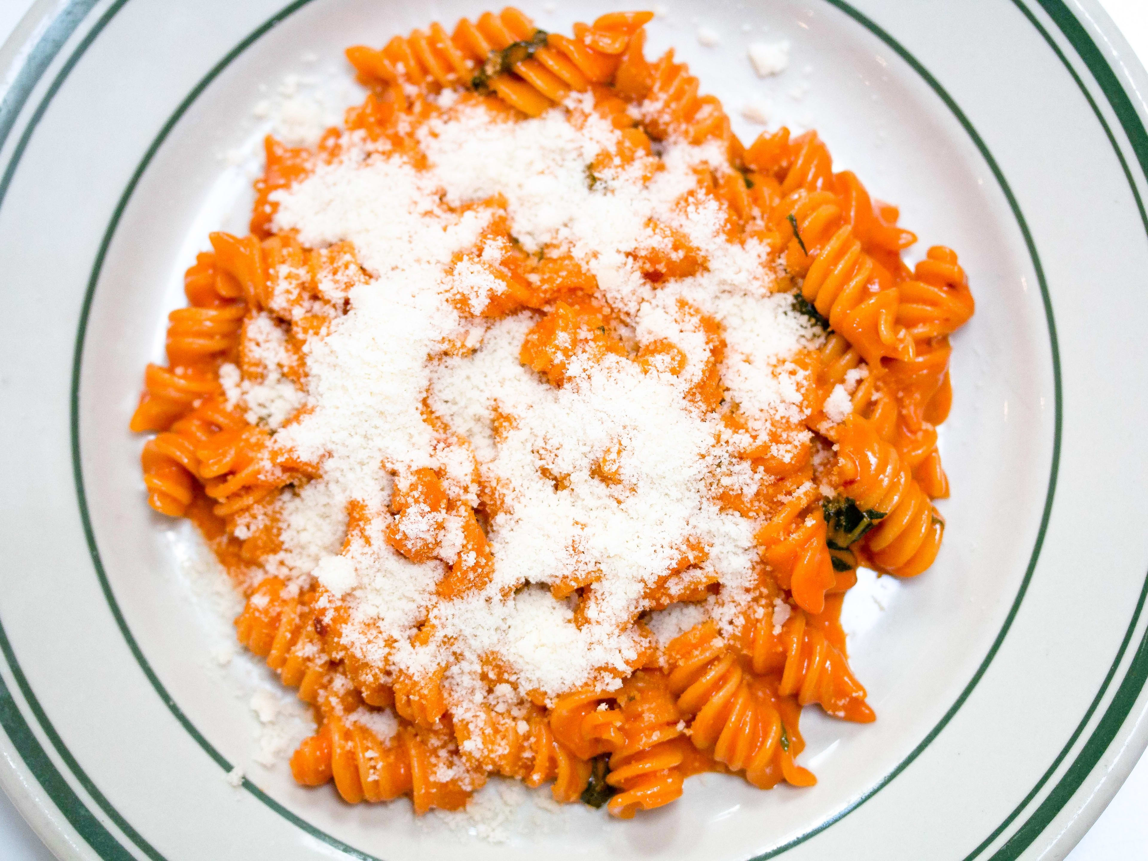 A plate of spicy fusilli from Jon & Vinny's with parmesan sprinkled on top.