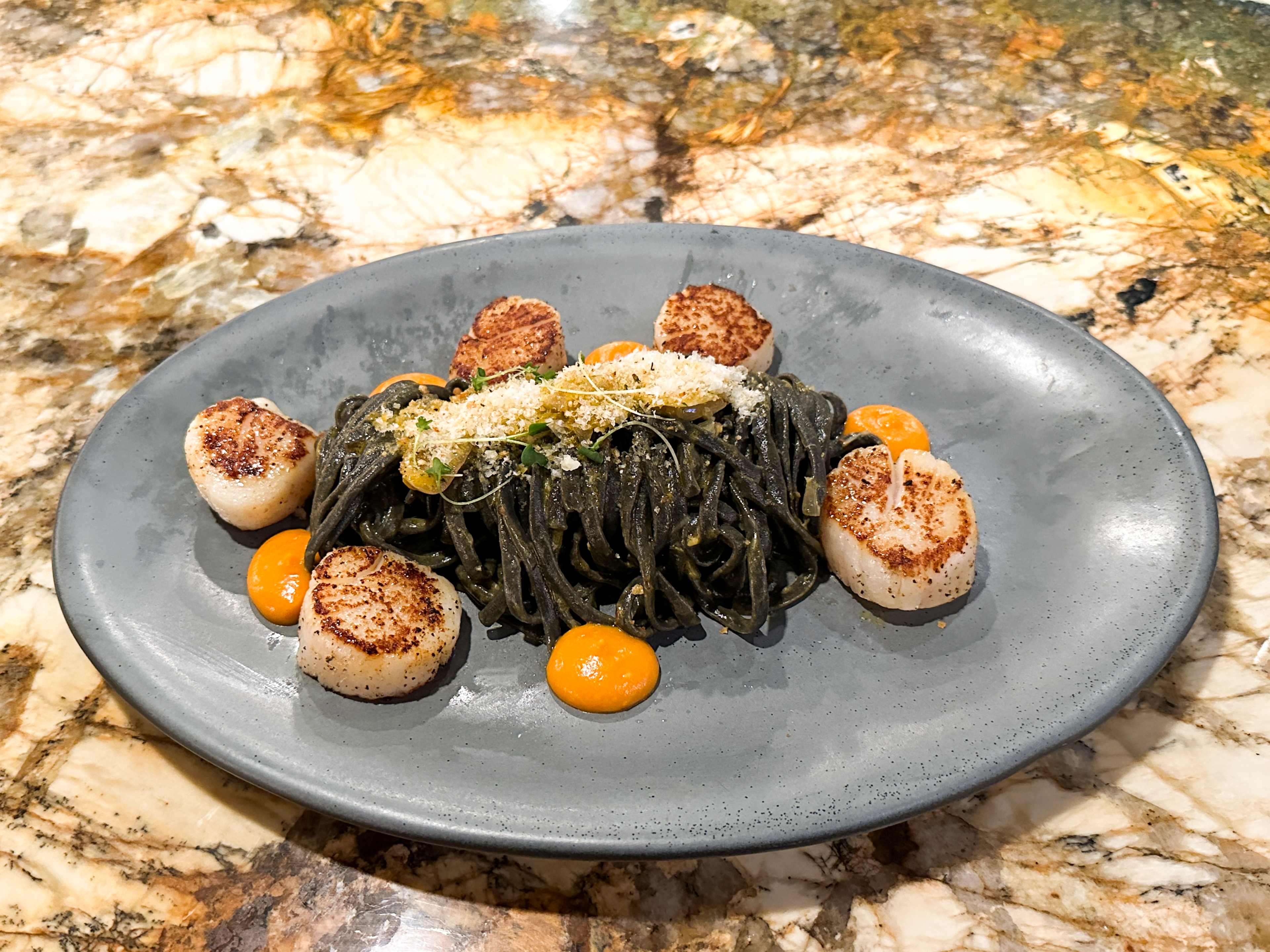 The sea scallops with squid ink linguini from Plank.
