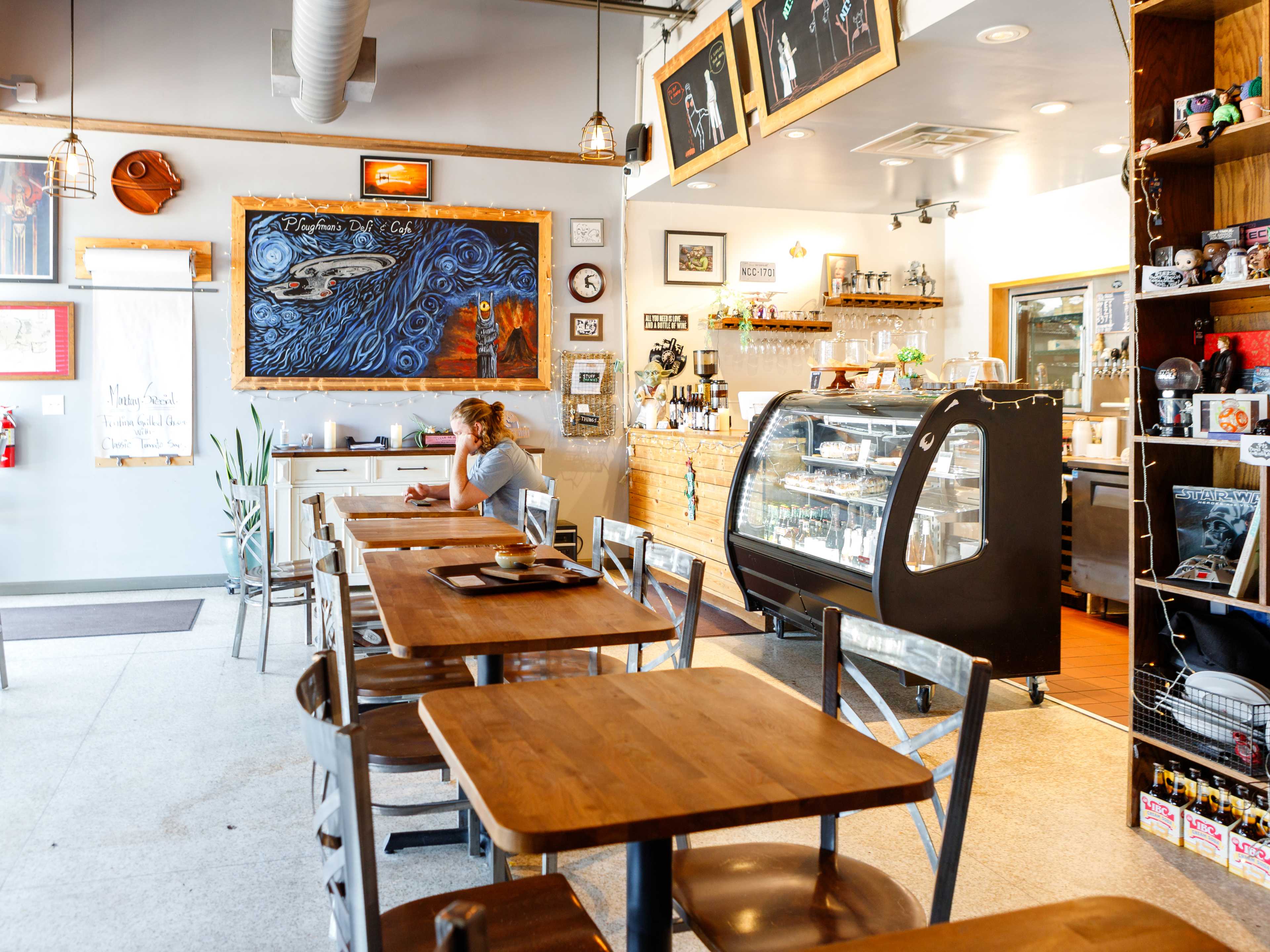 interior of Ploughman's Deli with wood tables and deli counter