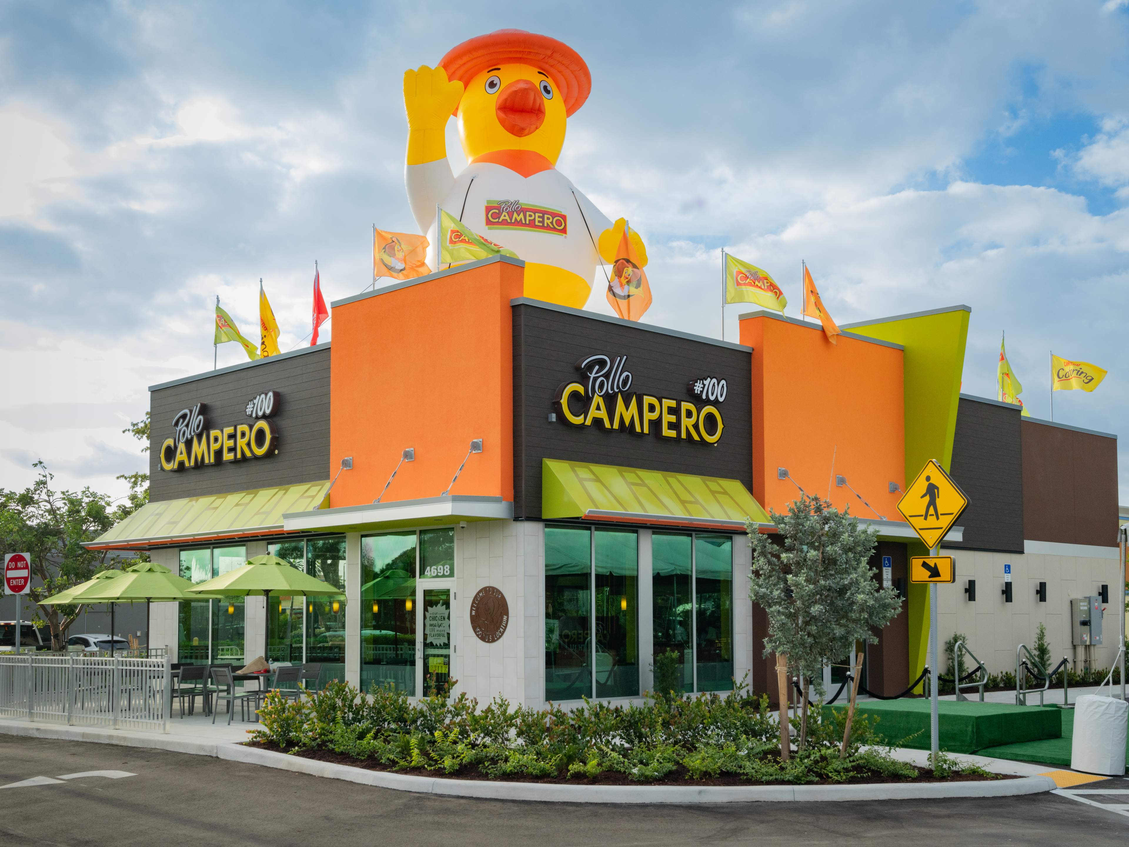 exterior of fast casual restaurant with giant inflatable rubber chicken on top