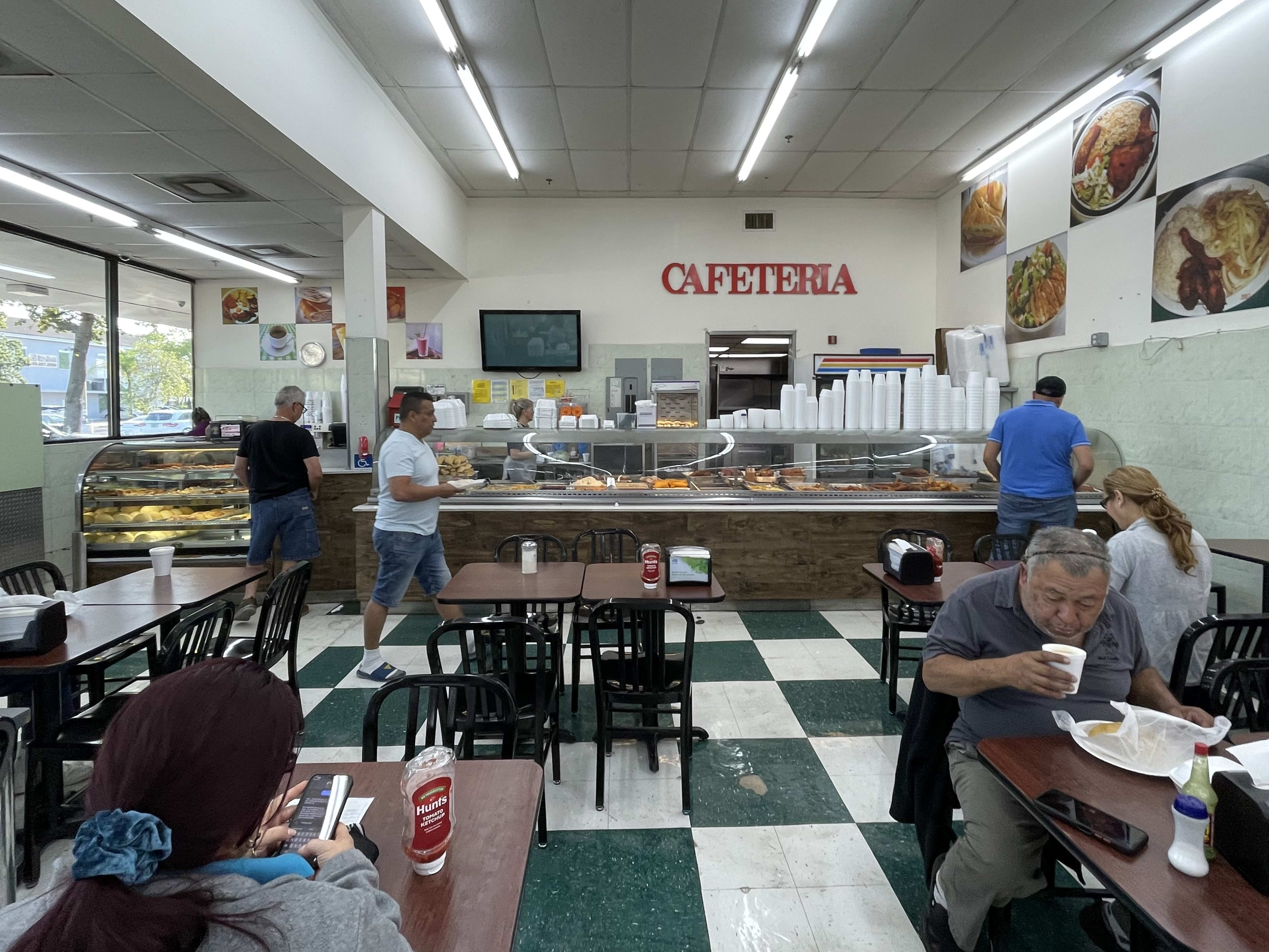 People eat in a supermarket cafeteria.