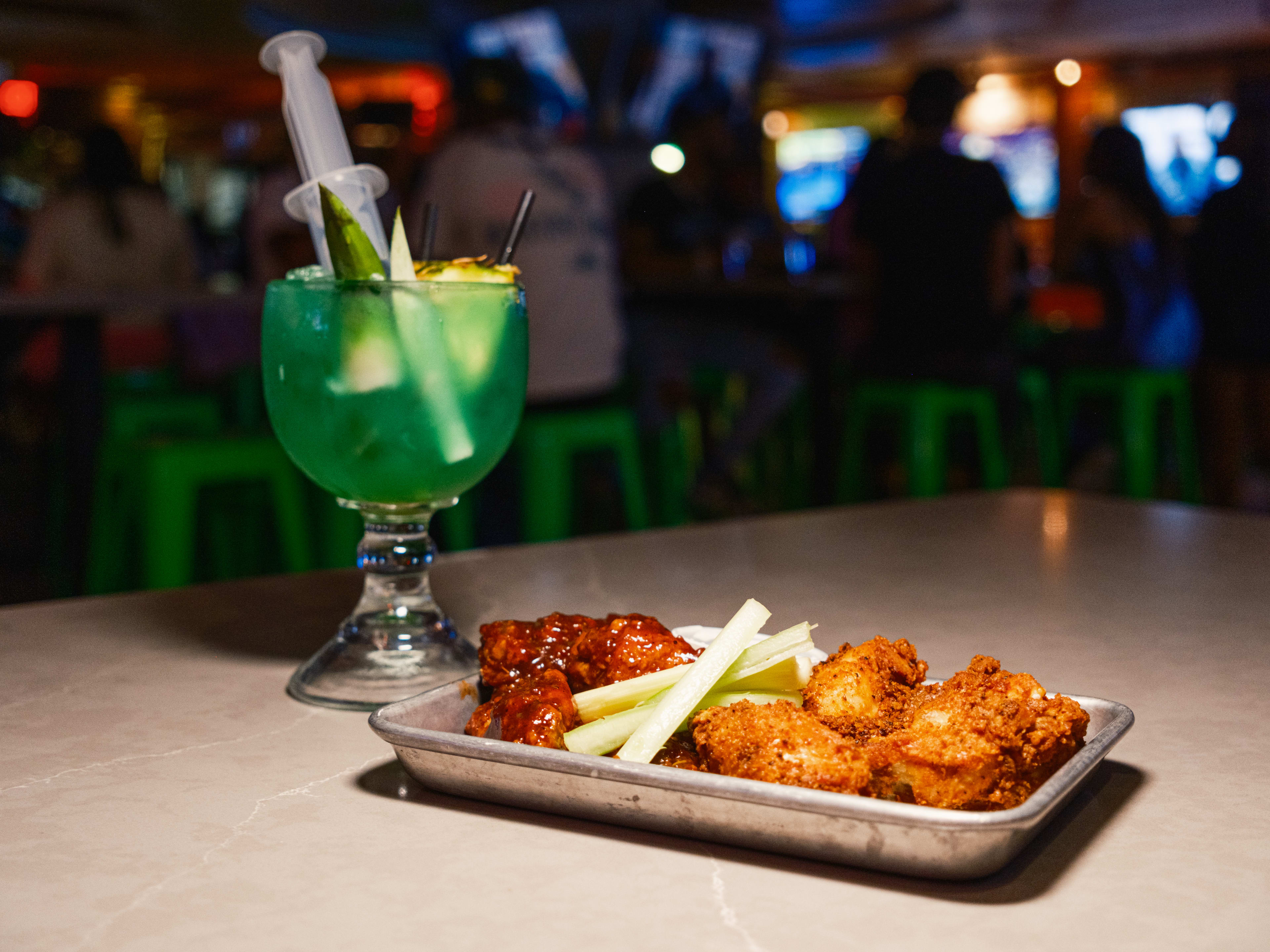 A tray of wings and the vaccine cocktail from Prospect Park.