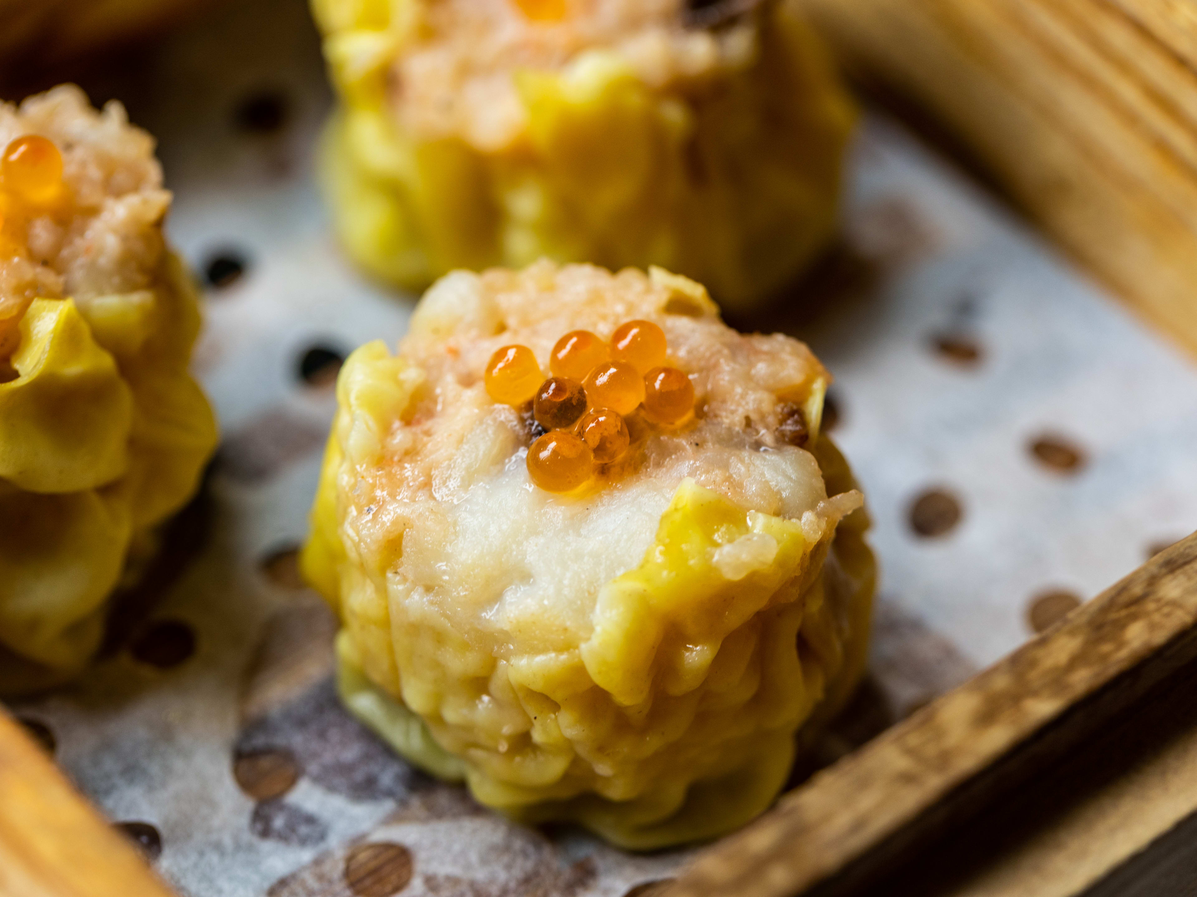 Scallop caviar siu mai in a steamer box.