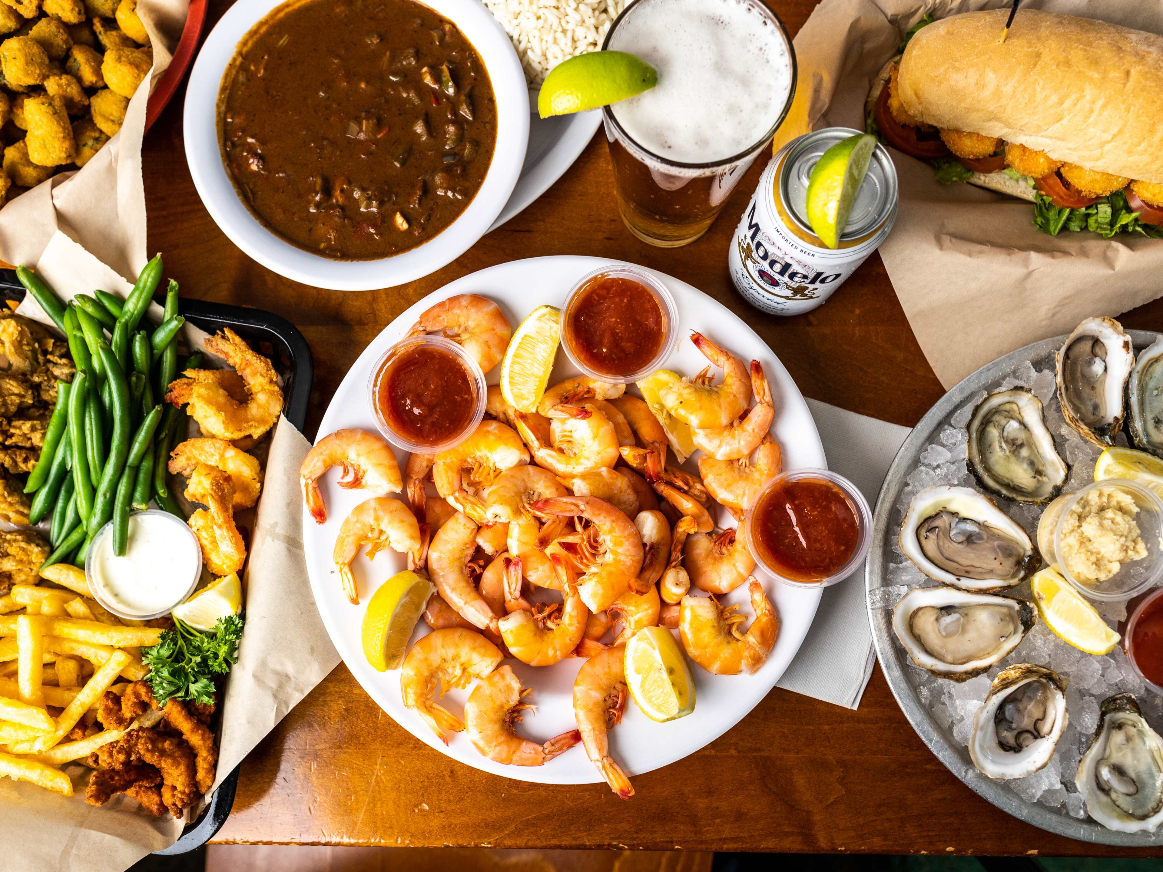 A spread of dishes and drinks on a table at Quality Seafood.