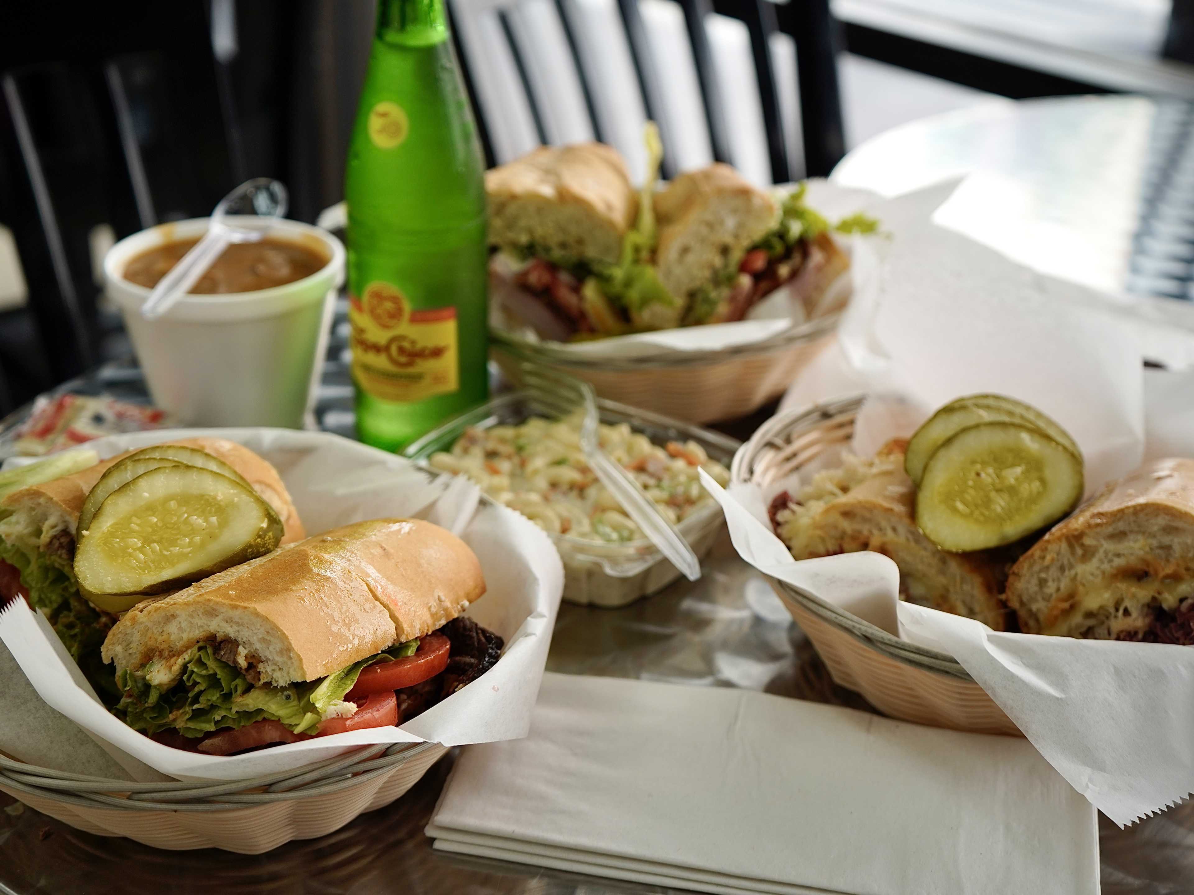 A spread of sandwiches and sides from Rae's Sandwich Shop.