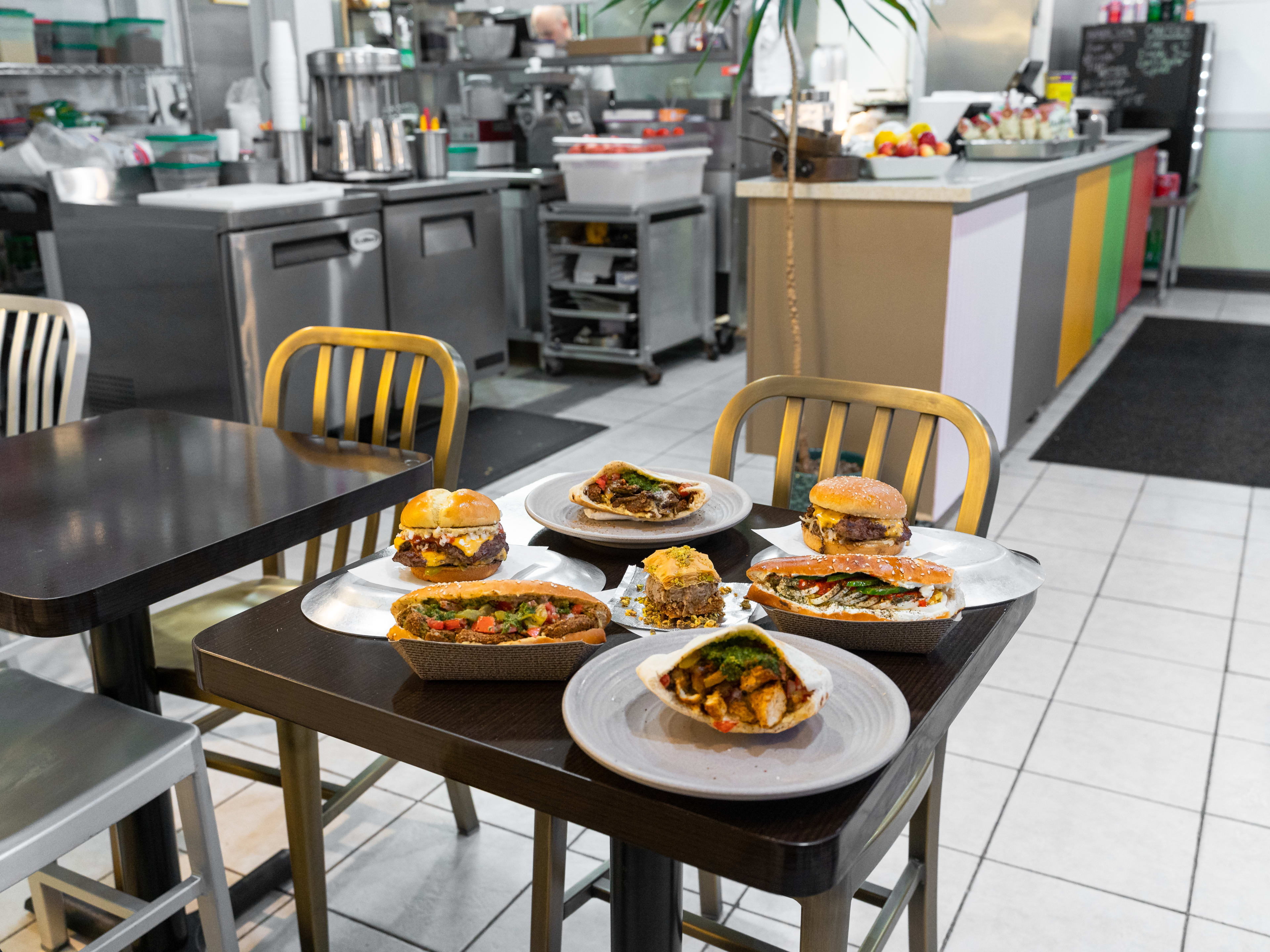 A spread of dishes on a black table inside Ragadan.