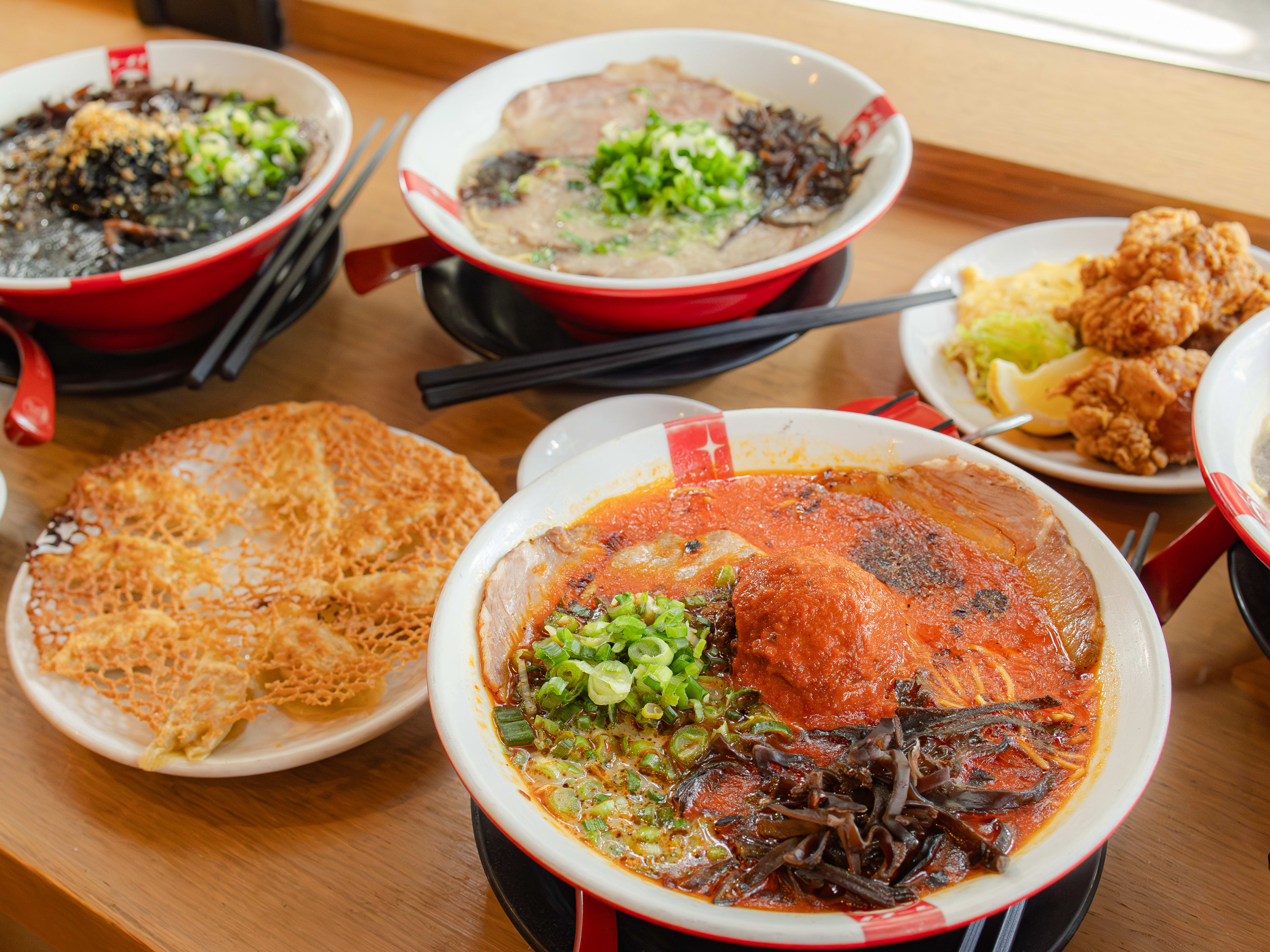 bowls of ramen and a plate of gyoza