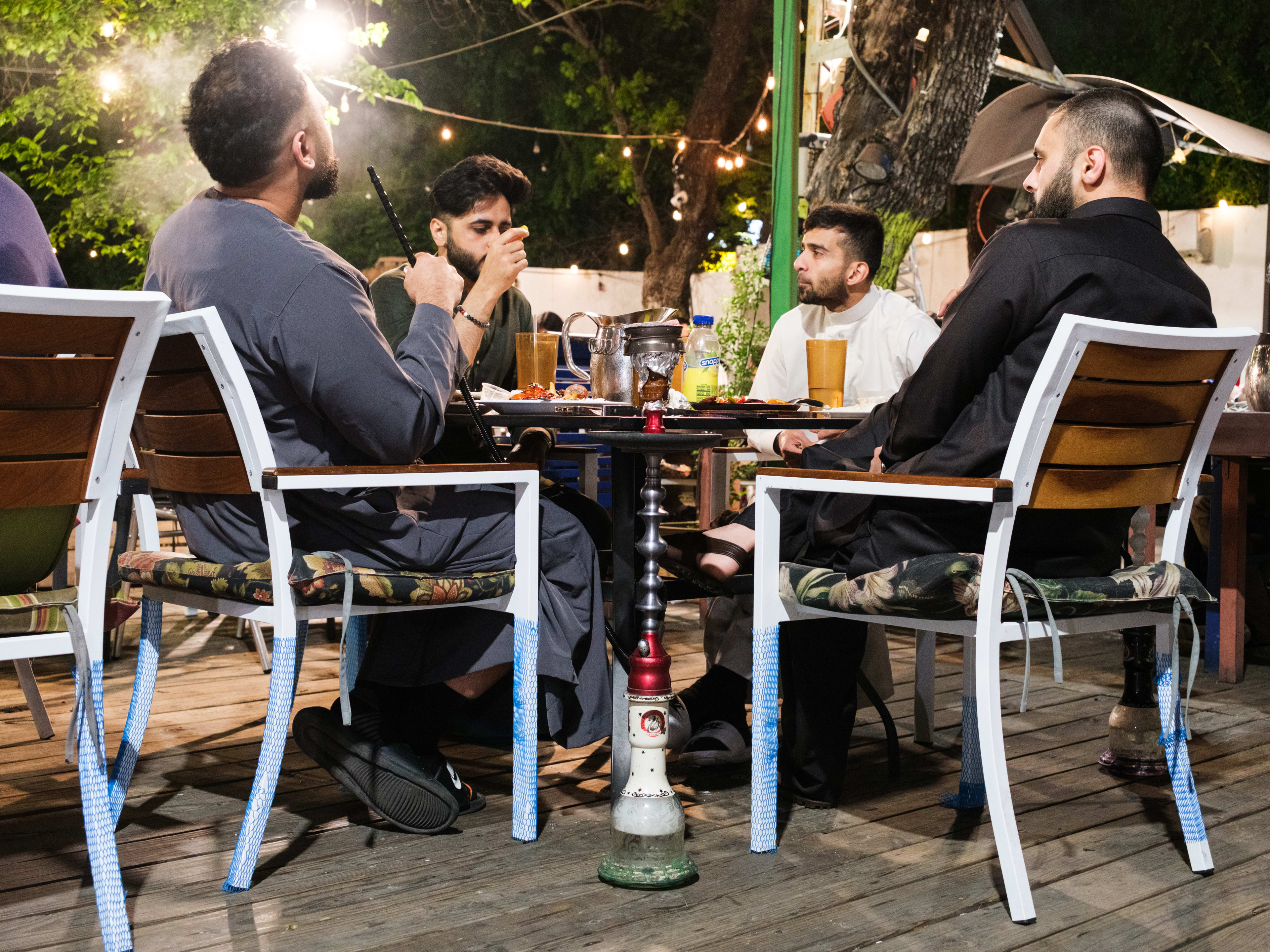 A table of four drink and smoke hookah at Ranosh Cafe.