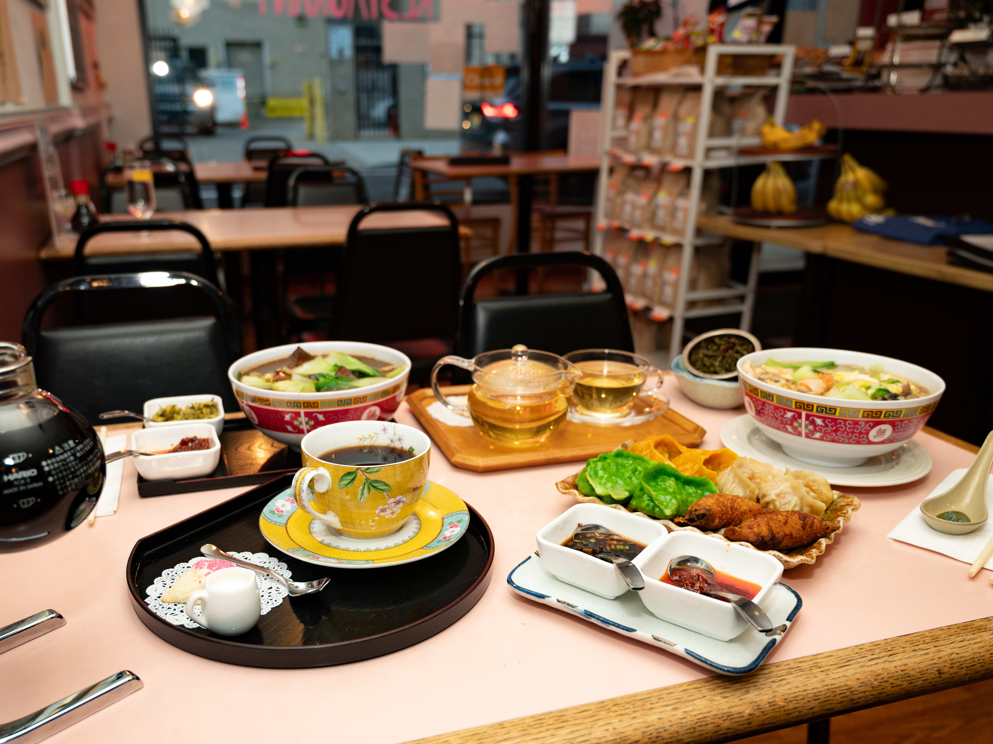 This is the food spread at Ray's Tea Cafe, which includes dumplings, tea, siphon coffee, and noodle soup.