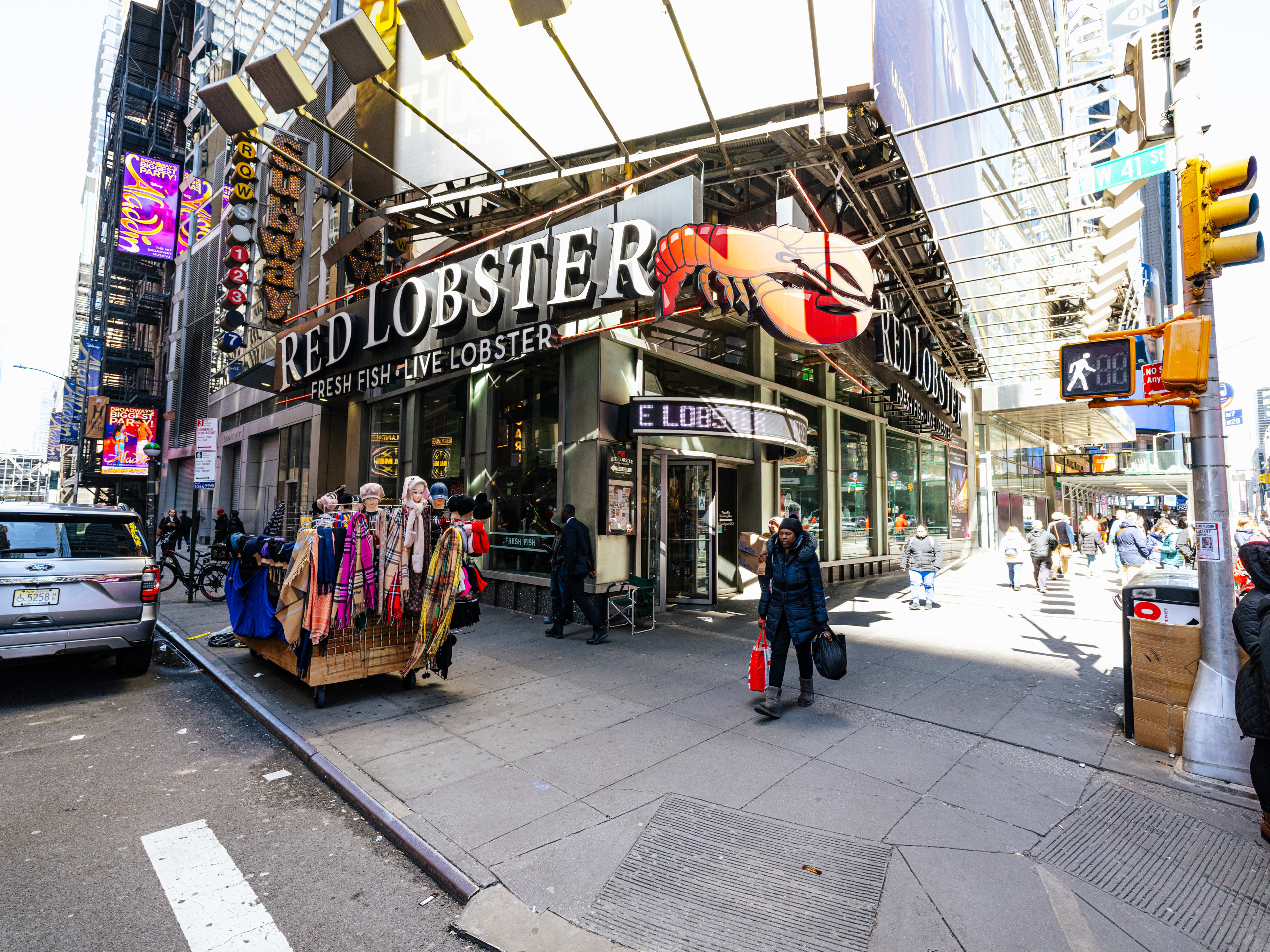 The exterior of Red Lobster in Times Square, with a big sign out front that does indeed have a huge red lobster on it.