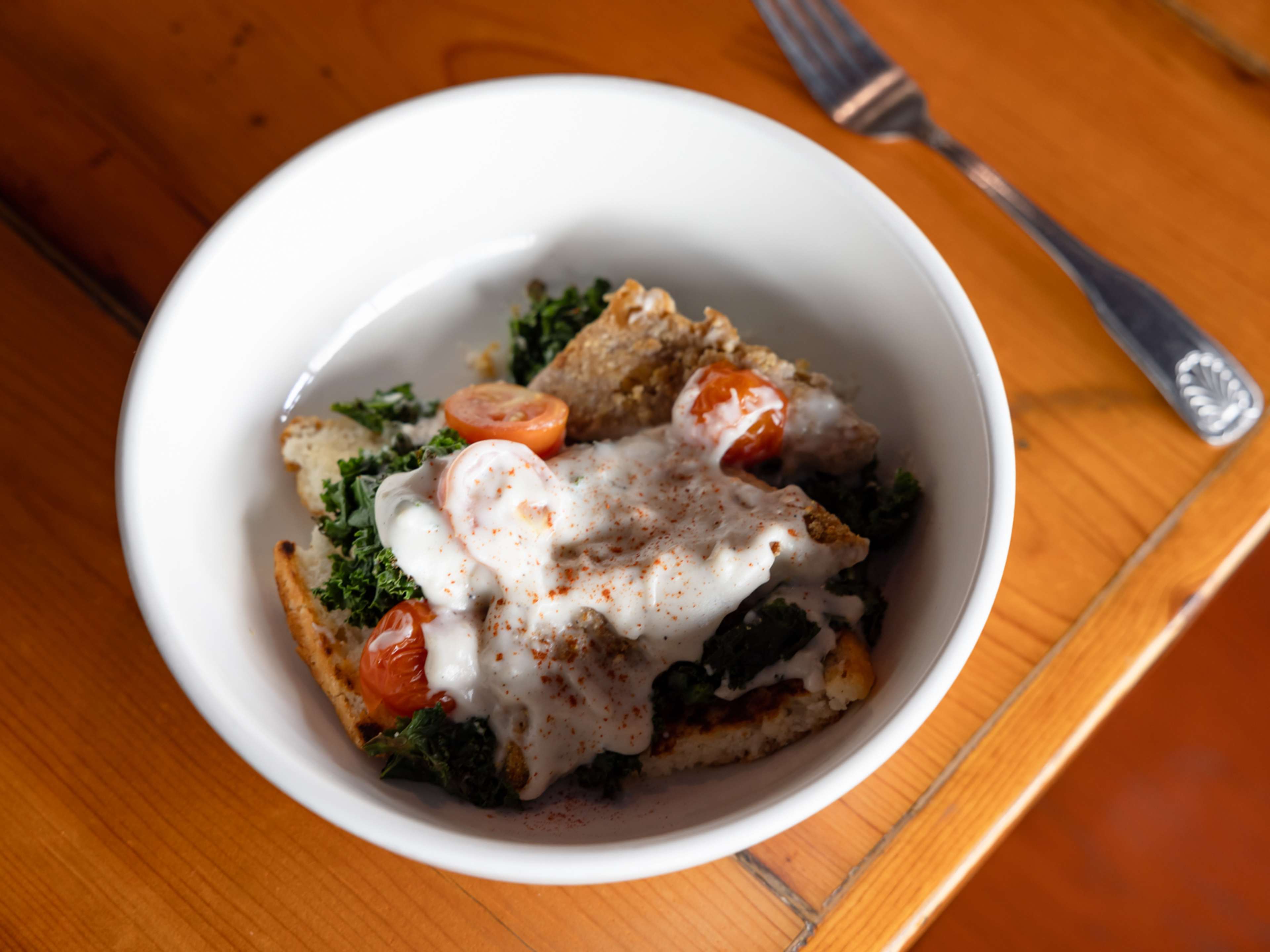 Country Fried Tempeh with white pepper gravy, tomatoes, and kale