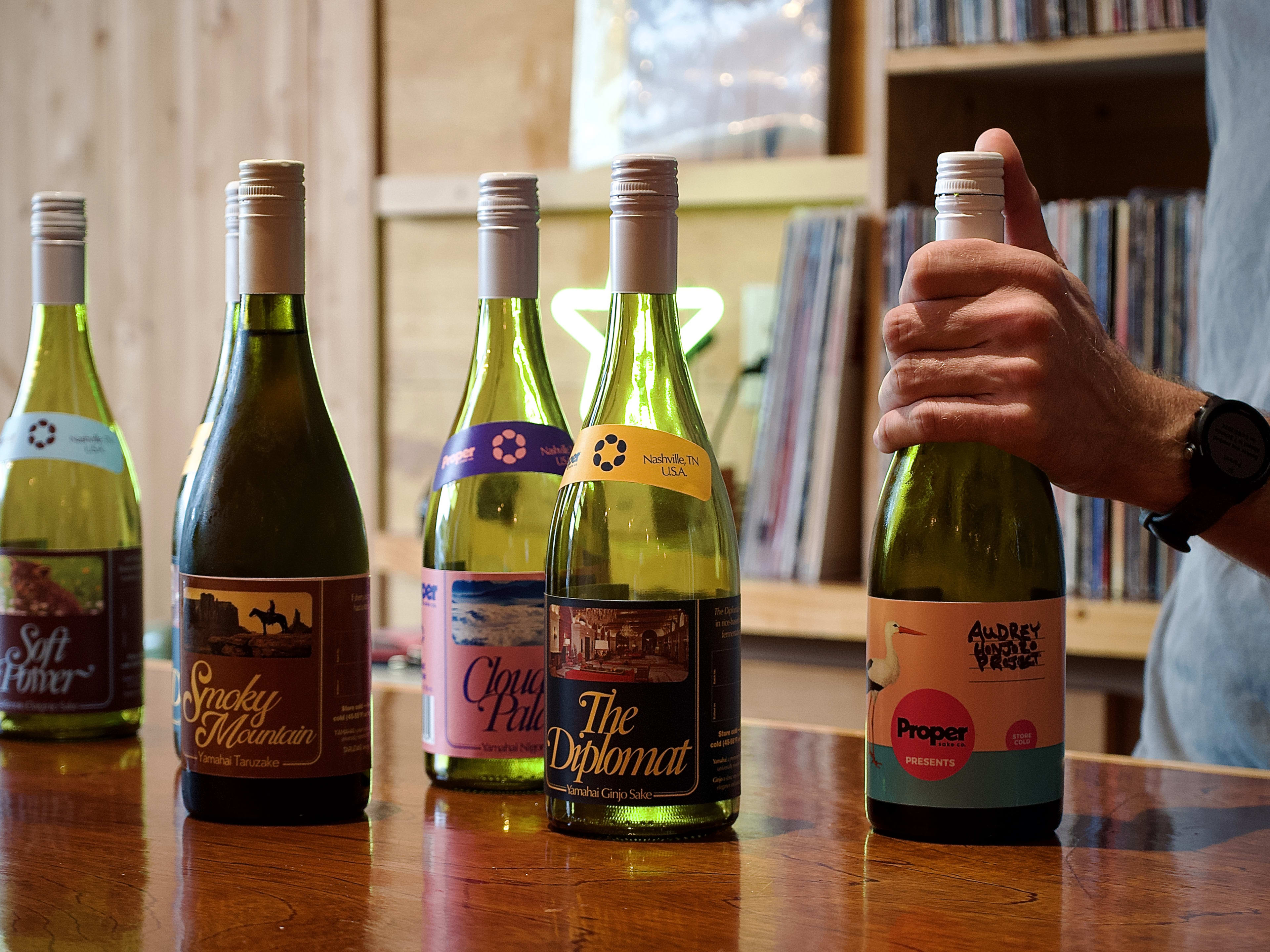 Array of craft sake bottles on bar at Rice Vice