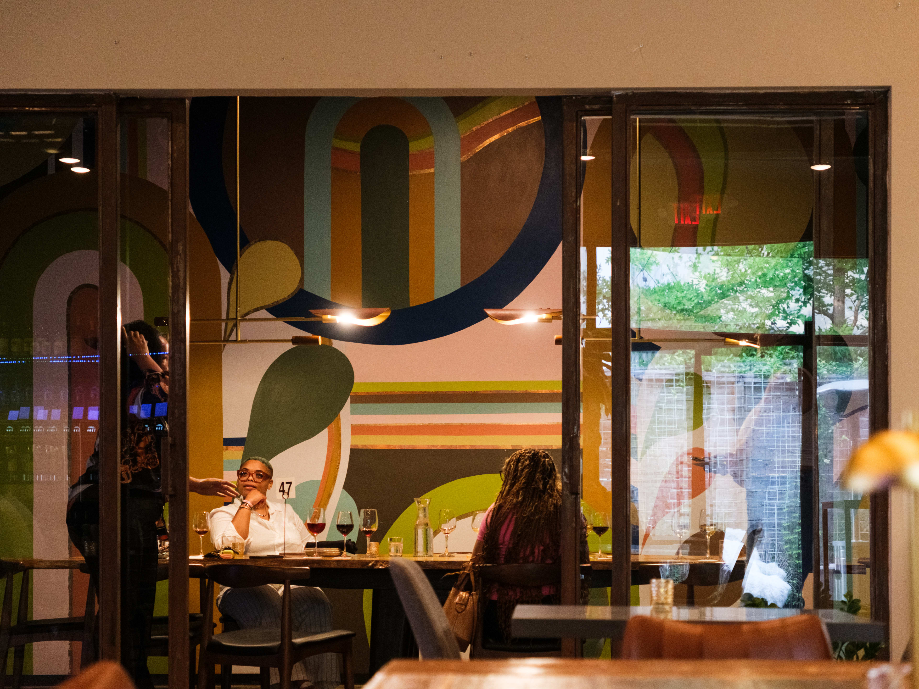 A private table in a glass enclosed room at Roots Wine Bar.