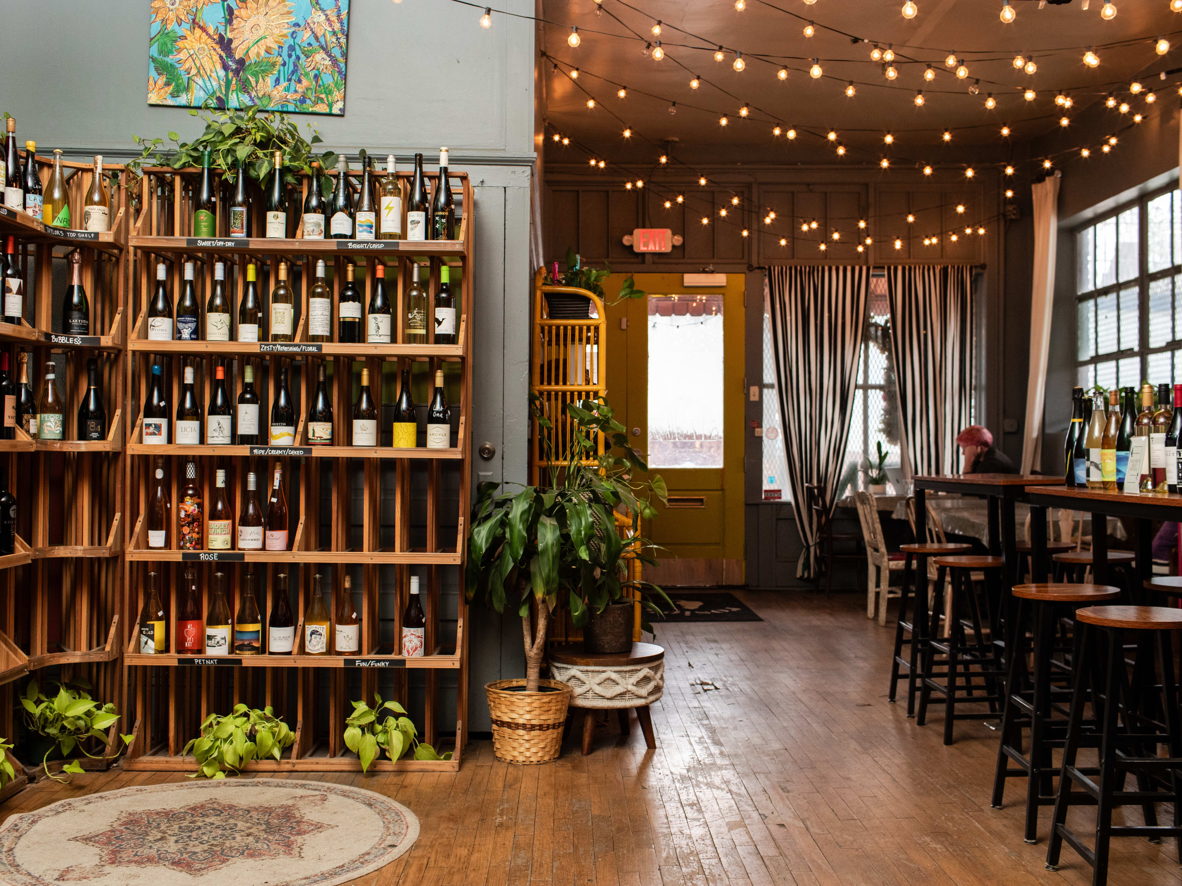 Interior Seating Area and wall of wine bottles at Rosie's Coffee & Wine