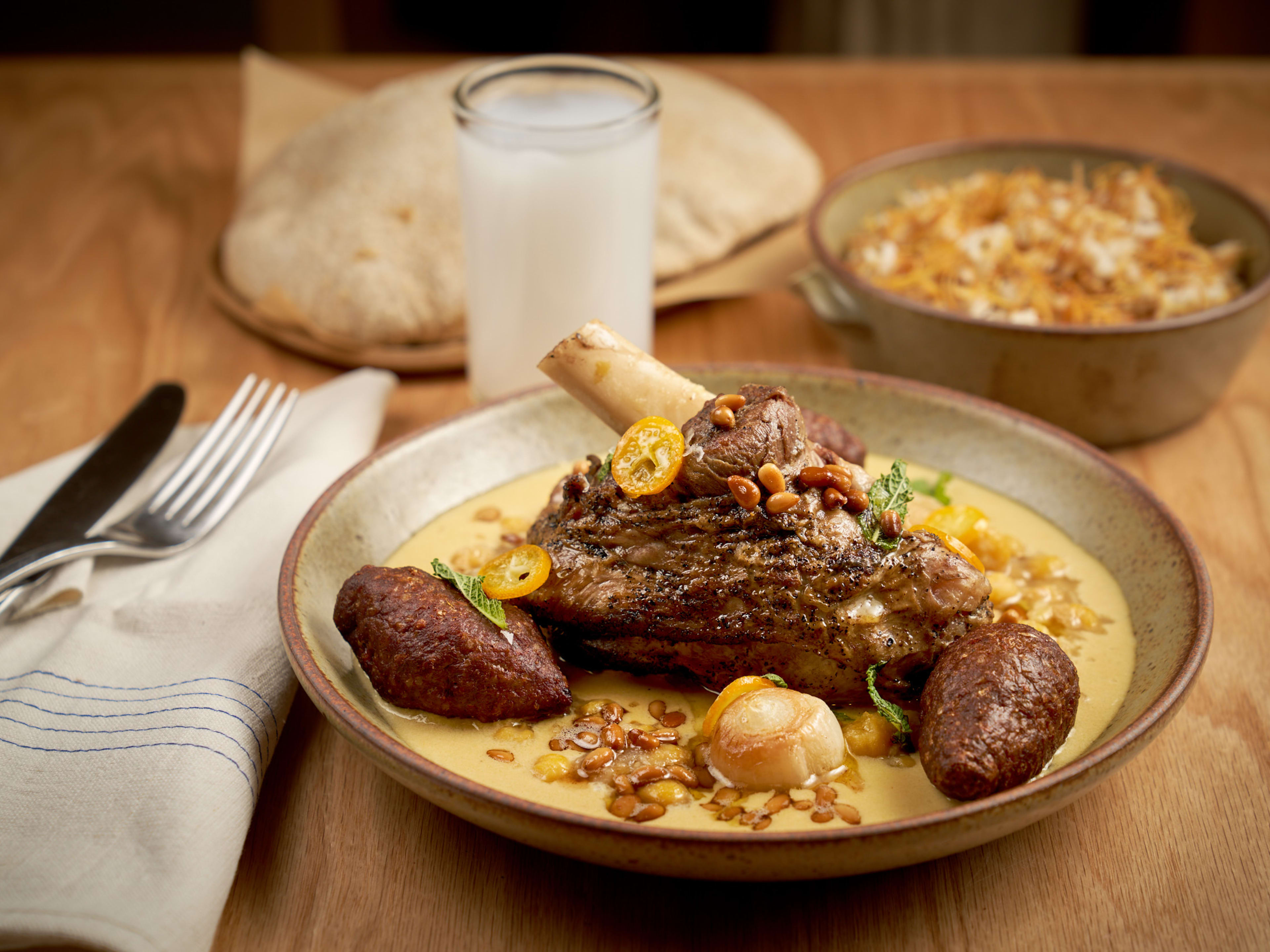 a roasted lamb shank with citrus and tahini