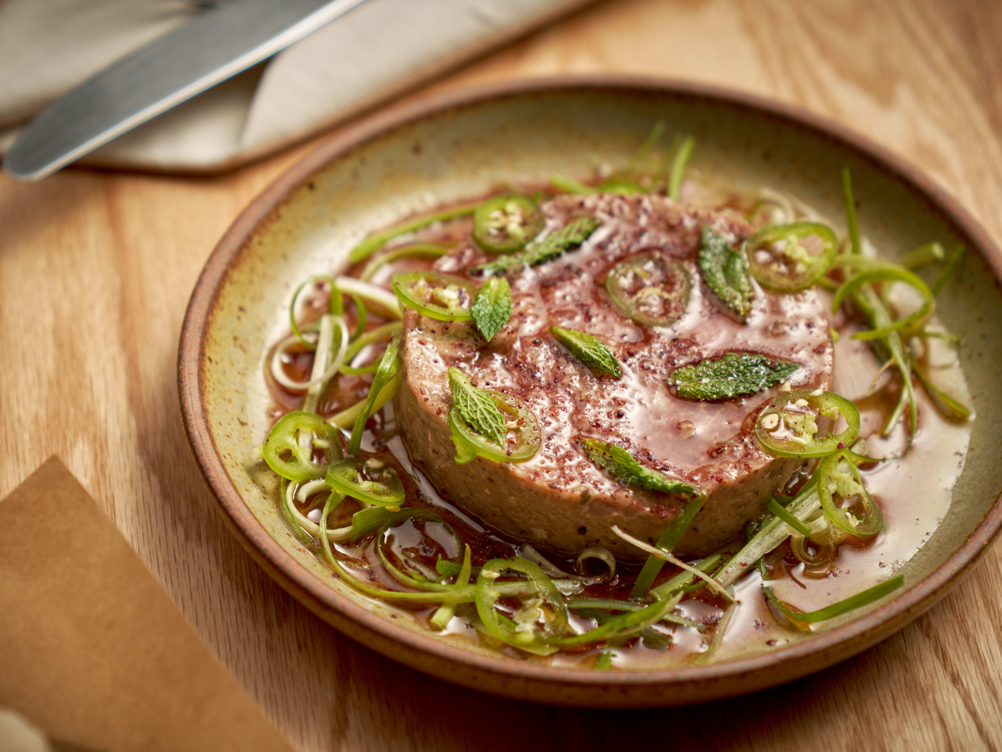 kibbeh nayeh with scallion curls, mint, and chilies