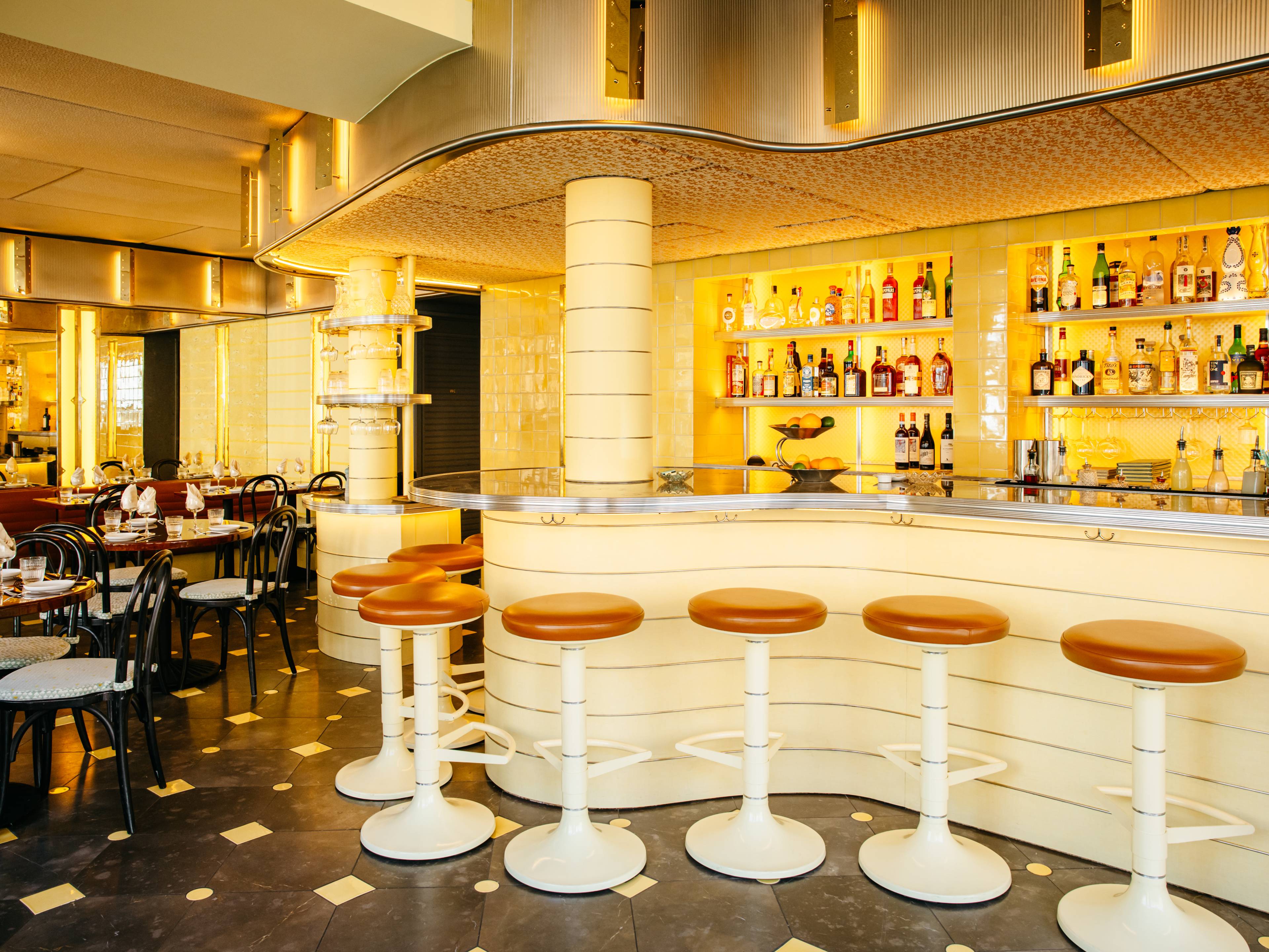 A bright dining room with a curved bar.