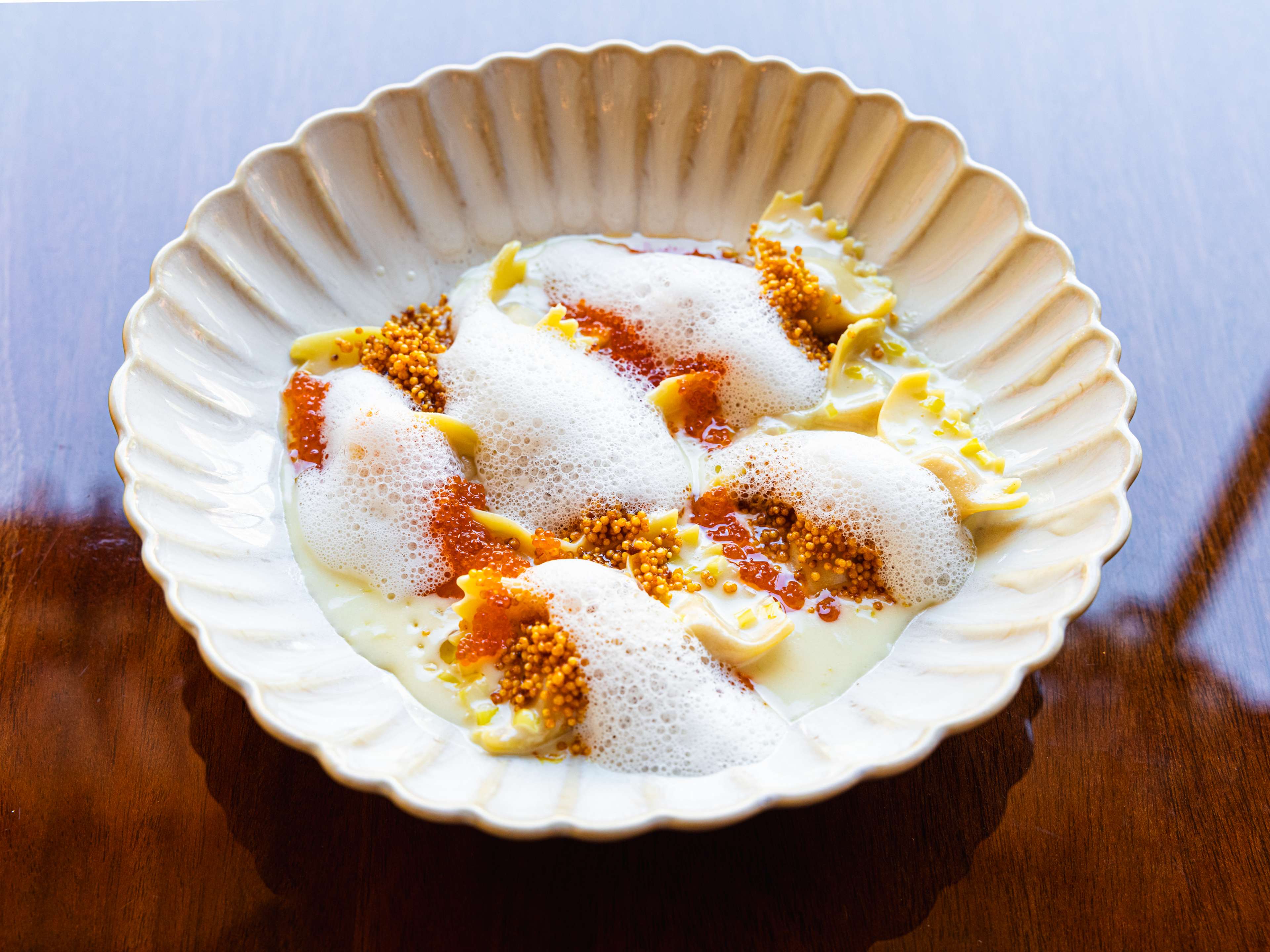 stuffed farfalled with chili crab, crunchy rice crackers, buttermilk foam, and tobiko