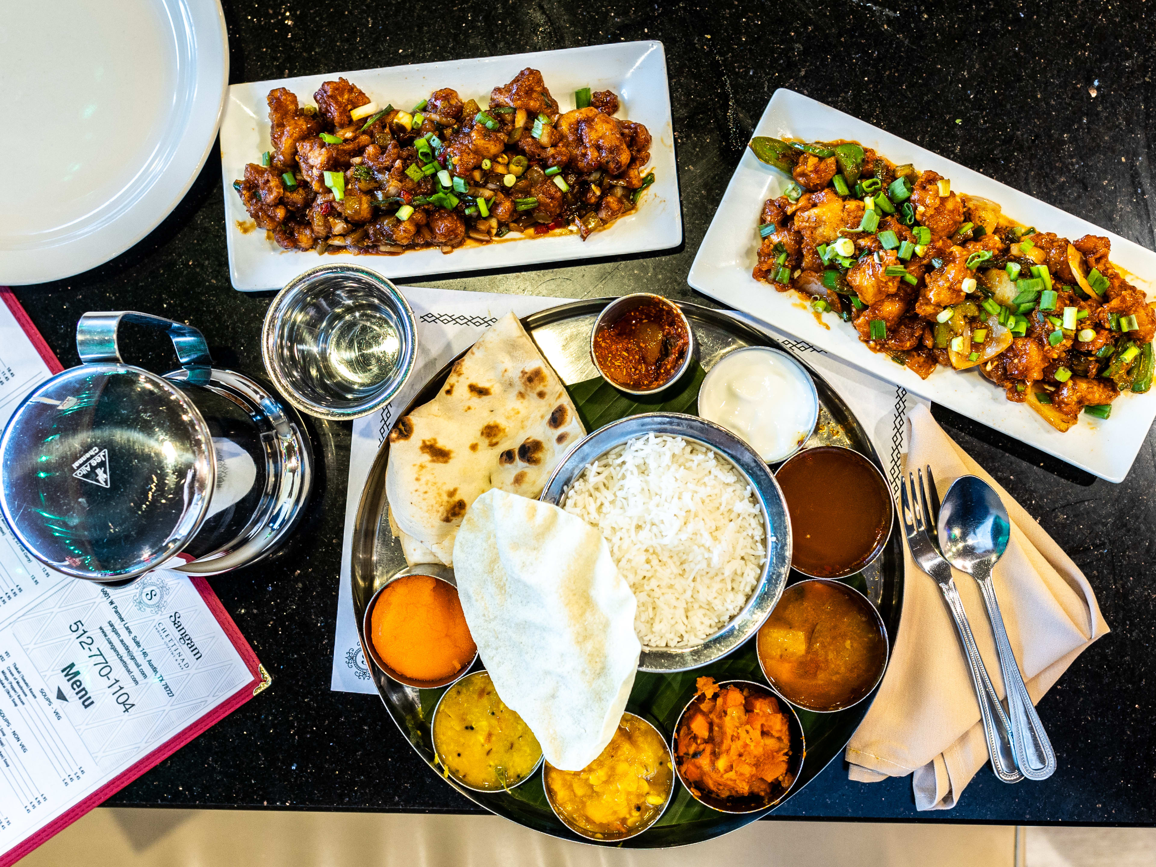 A spread of dishes on a table at Sangam Chettinad.