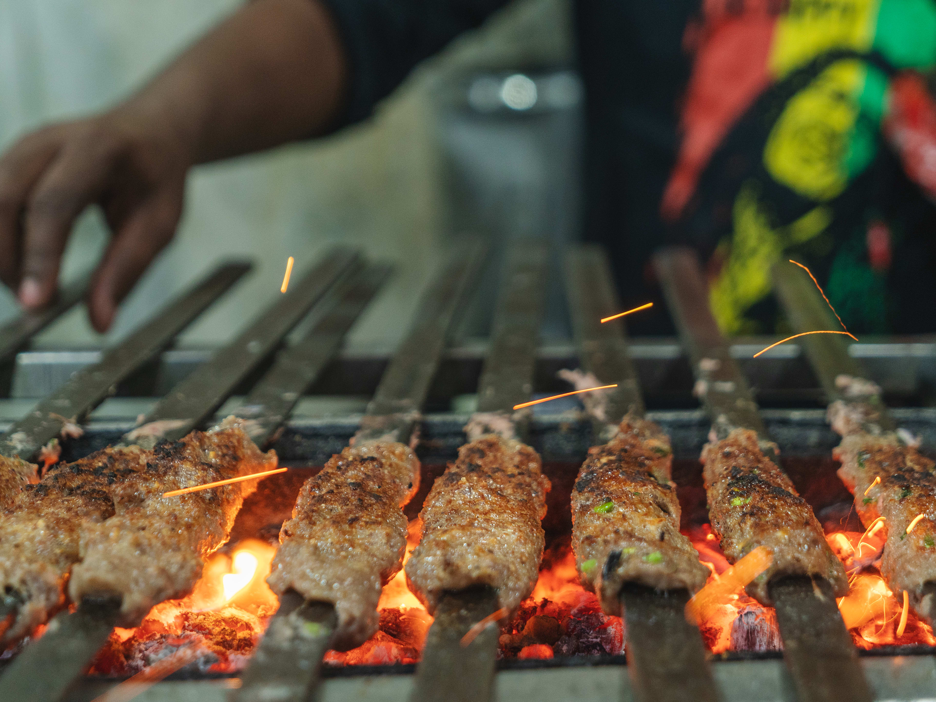 Kebabs grilling over an open flame at Sarvi