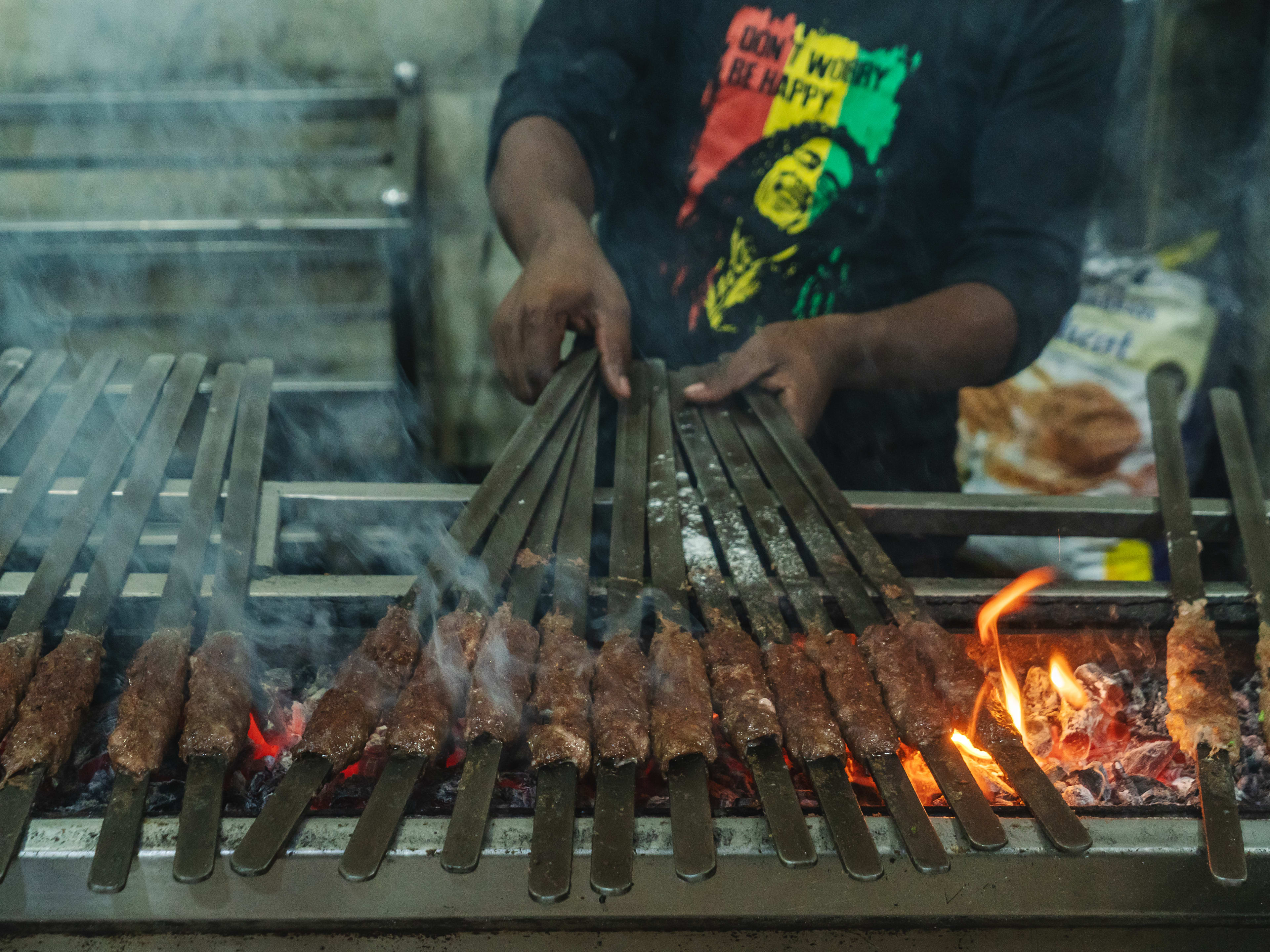 Seekh kebabs on an open grill at Sarvi